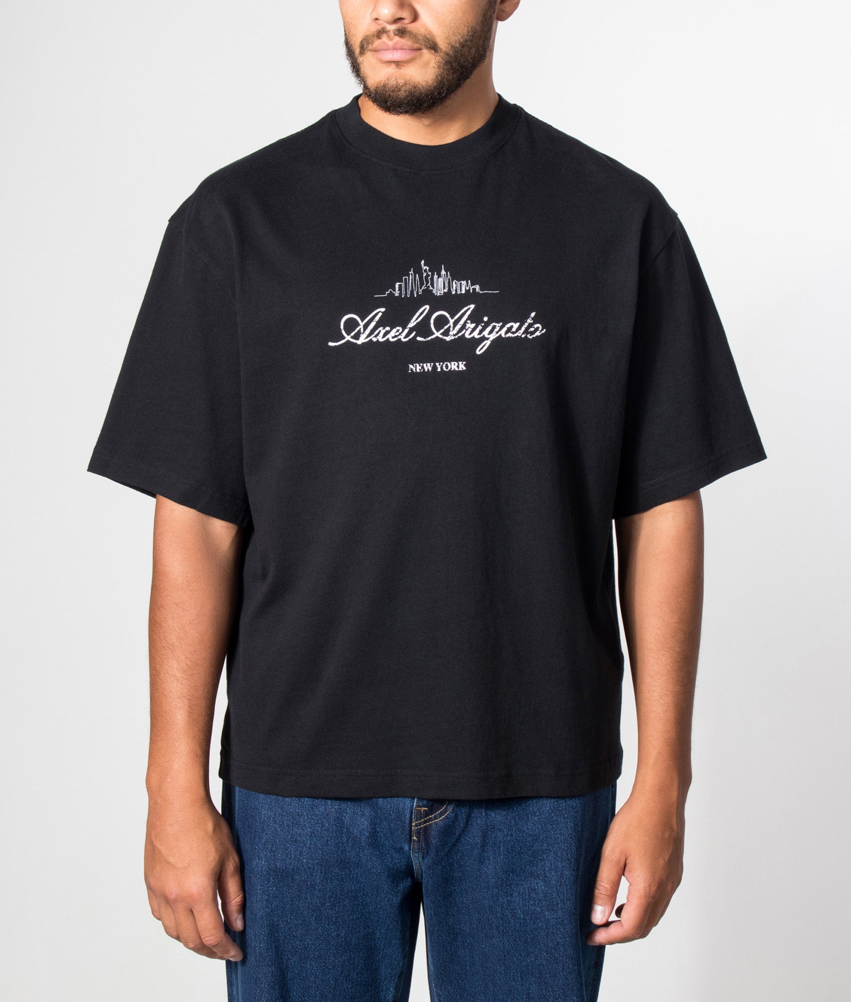 Axel Arigato Oversized Fit NYC Sky T-Shirt in Black at EQVVS Menswear. Model front shot.