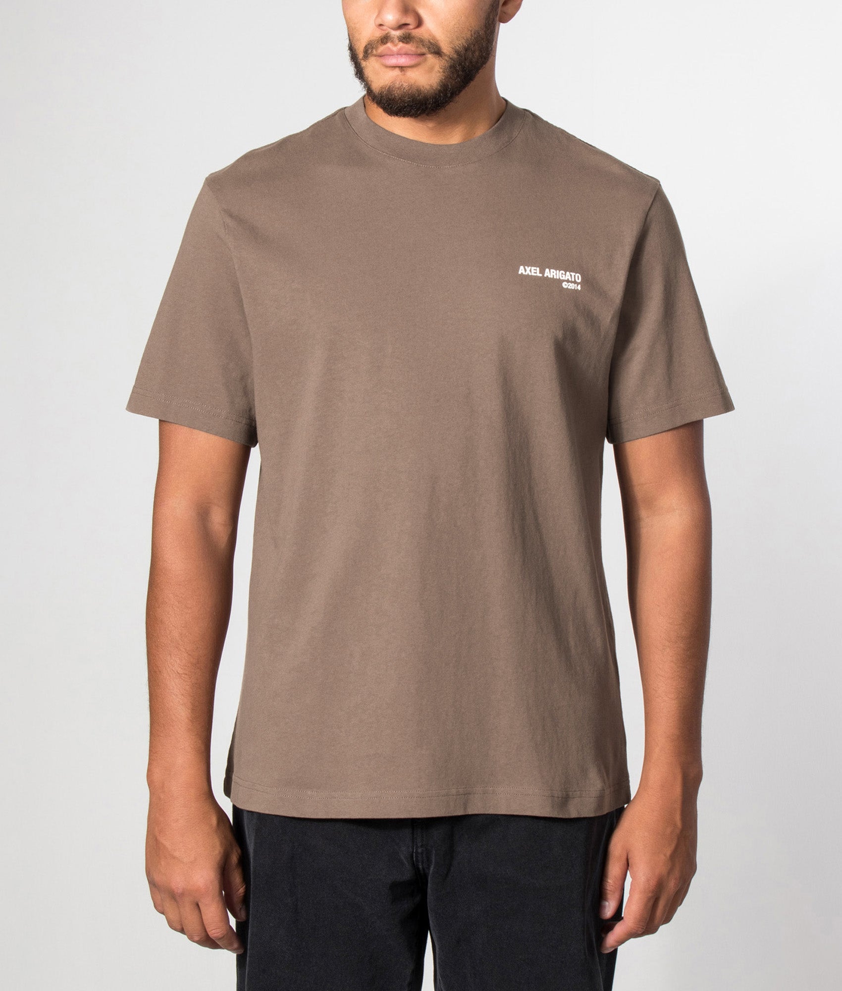 Axel Arigato Relaxed Fit Legacy T-Shirt in Coffee Brown at EQVVS Menswear. Model front shot.