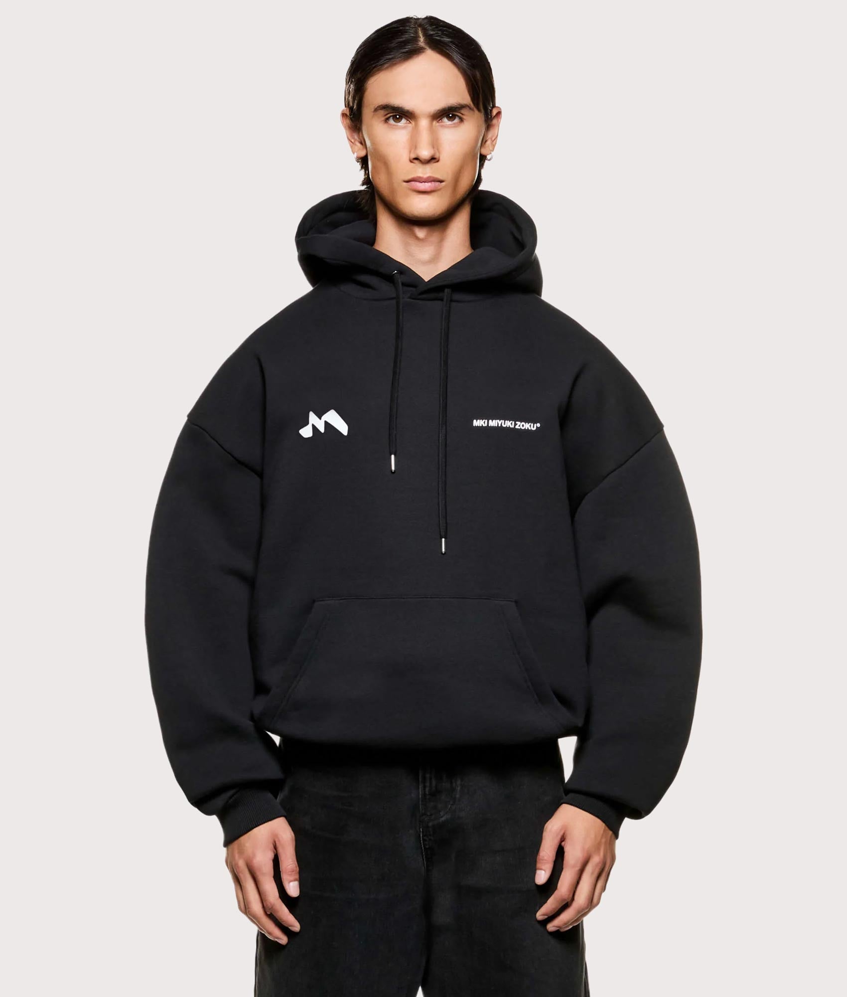 MKI MIYUKI ZOKU Silhouette Hoodie in Black at EQVVS Menswear. Model front shot.
