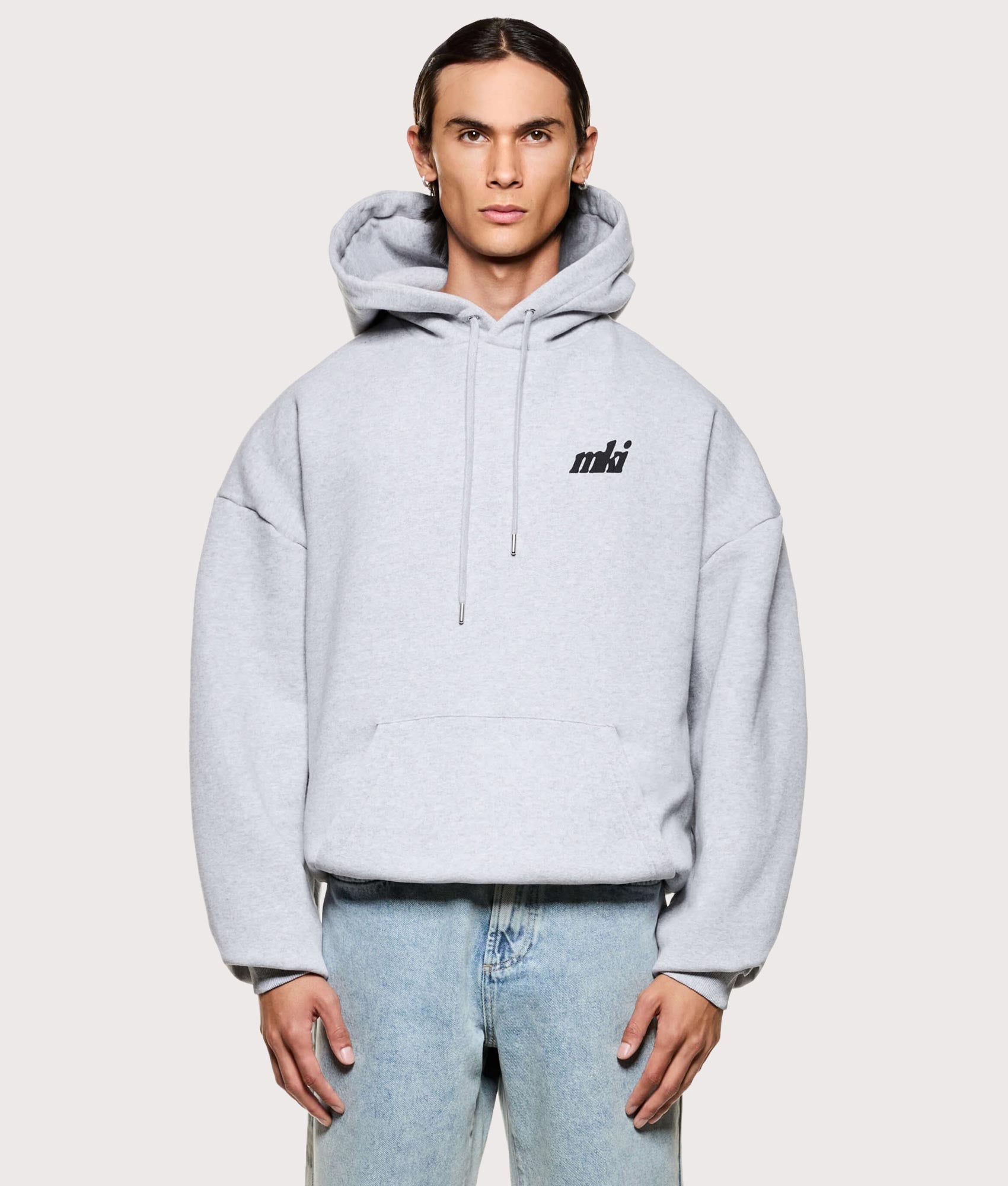 MKI MIYUKI ZOKU Stamp Hoodie in grey at EQVVS Menswear. Model front shot.
