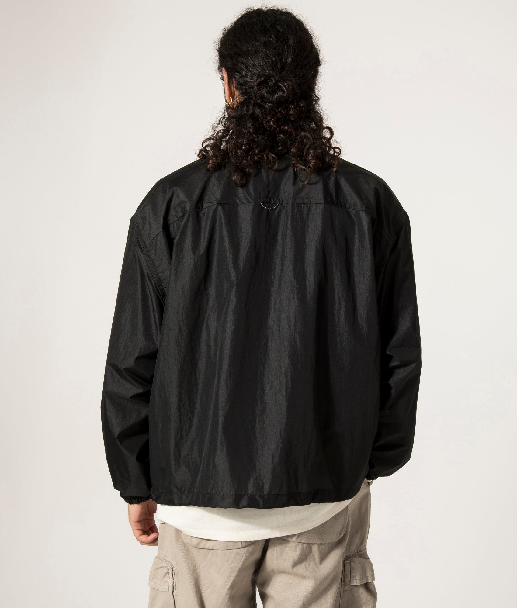 and Wander Oversized Rip Jacket in Black. Shot at EQVVS. Back Model Shot.