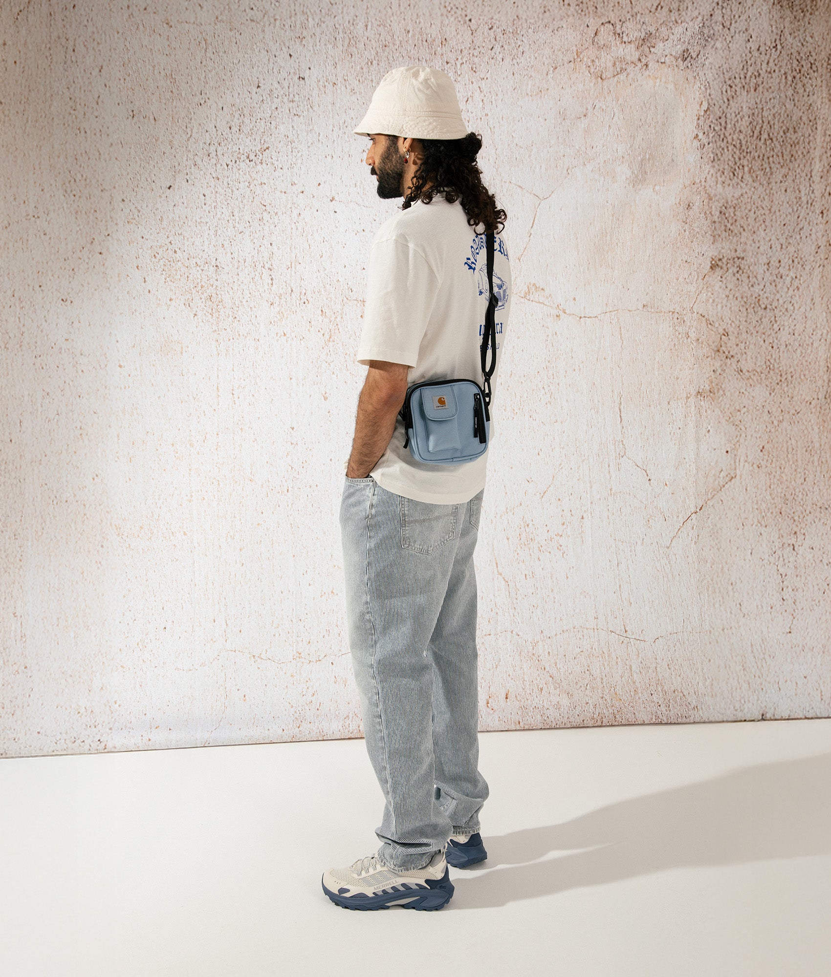 Carhartt WIP Small Essentials Bag in Misty Sky. Campaign shot at EQVVS.