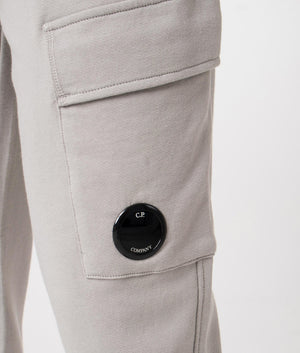 CP Company Diagonal Raised Fleece Cargo Joggers in Drizzle Grey Featuring the CP Goggle Detail Shot at EQVVS