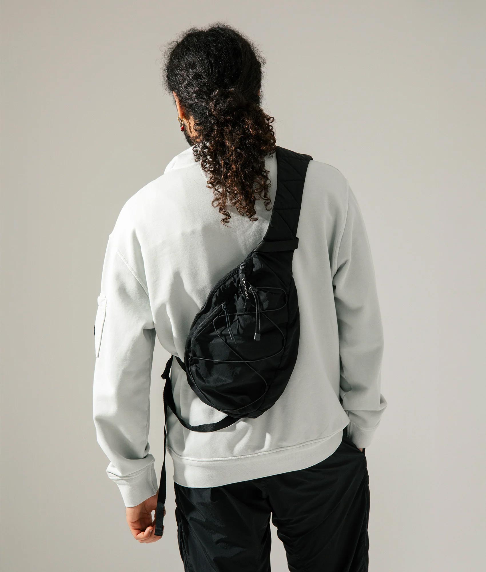 Nylon B Crossbody Rucksack. Shot by EQVVS. Model shot.