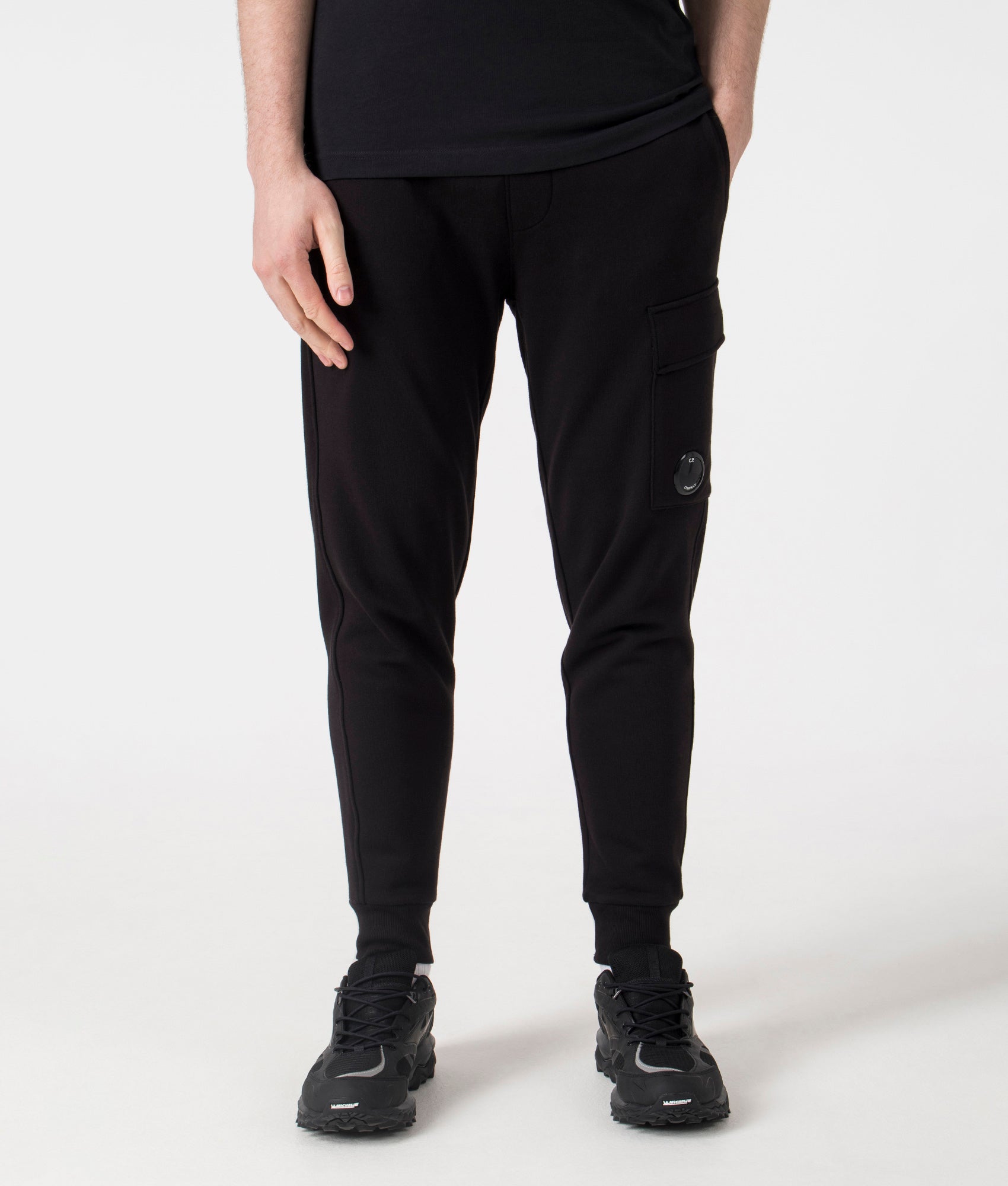 C.P. Company  Diagonal Raised Lens Joggers in Black. Shot at EQVVS. Front shot 