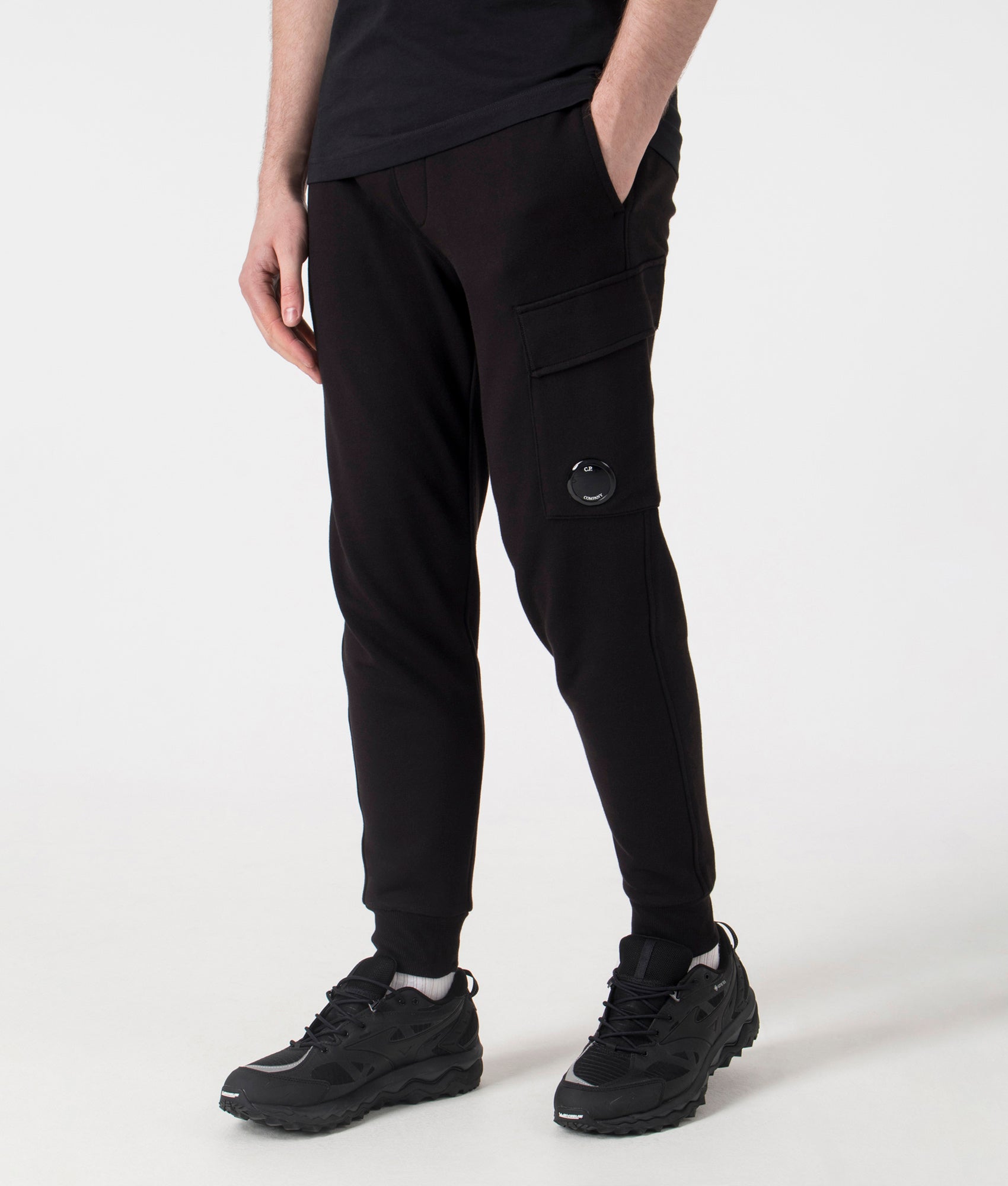 C.P. Company  Diagonal Raised Lens Joggers in Black. Shot at EQVVS. Front angle shot 