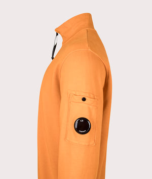 C.P. Company Diagonal Fleece Quarter Zip Sweatshirt in Russet Orange at EQVVS Menswear. Side detail shot.