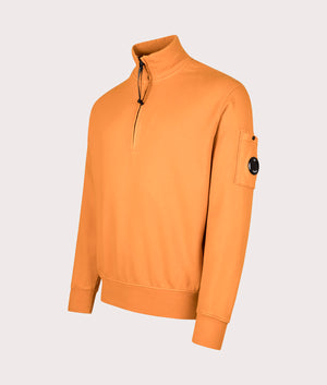 C.P. Company Diagonal Fleece Quarter Zip Sweatshirt in Russet Orange at EQVVS Menswear. Angled front shot.