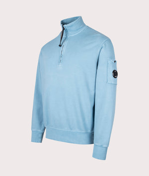C.P. Company Diagonal Fleece Quarter Zip Sweatshirt in Aegean Blue at EQVVS Menswear. Angled front shot. 