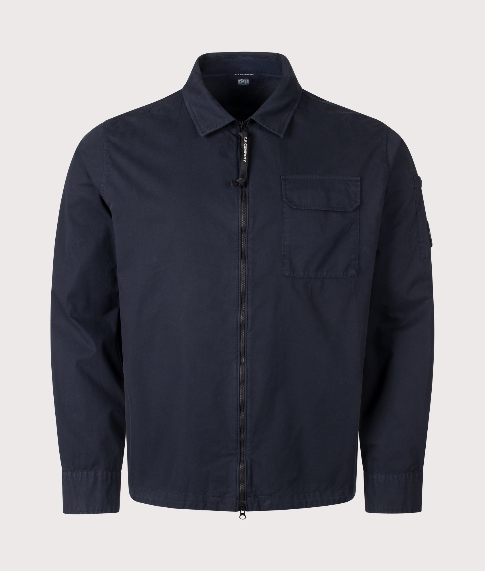 C.P. Company Organic Gabardine Zipped Lens Overshirt in Total Eclipse at EQVVS Menswear. Front shot.