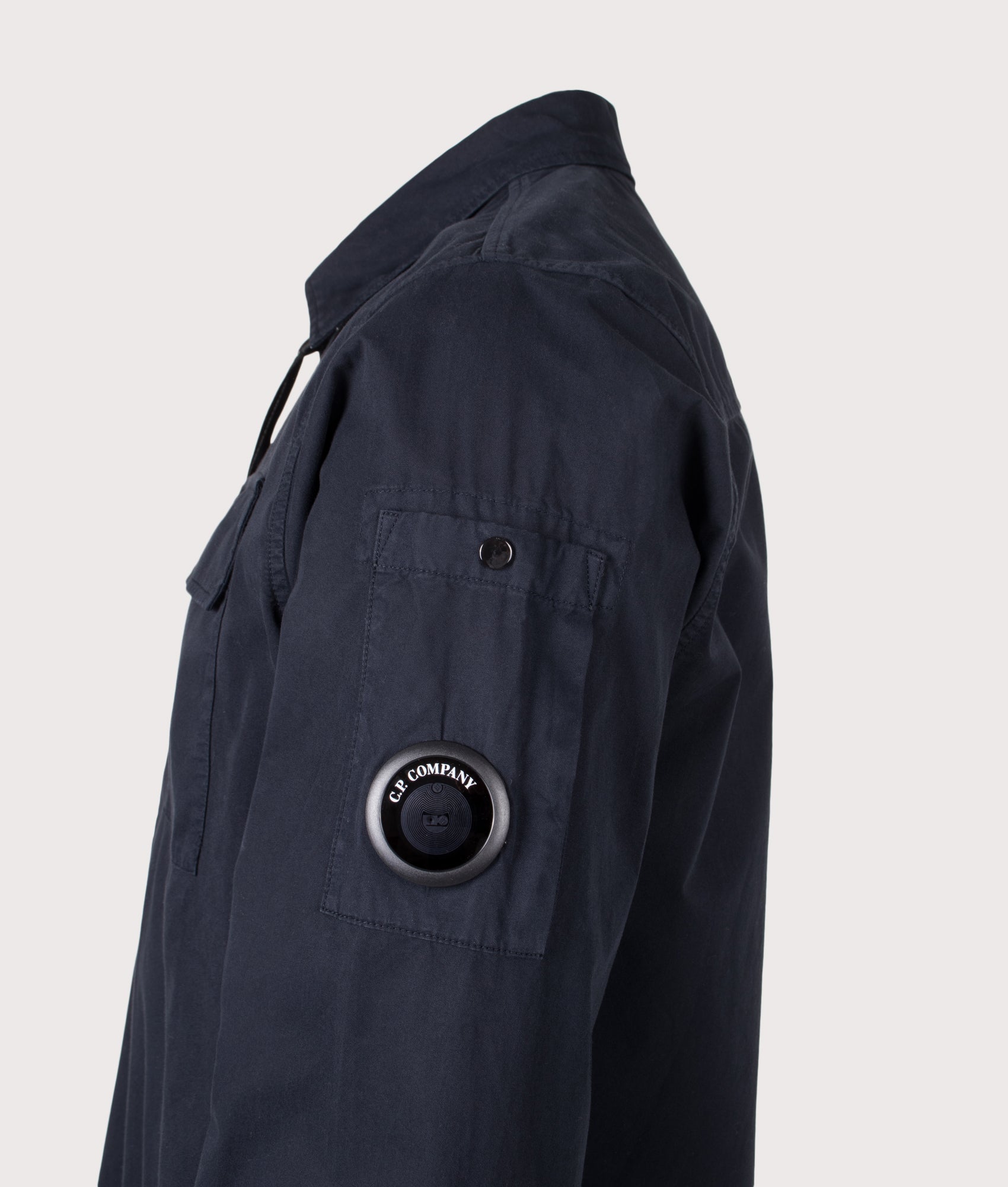 C.P. Company Organic Gabardine Zipped Lens Overshirt in Total Eclipse at EQVVS Menswear. Detail shot.