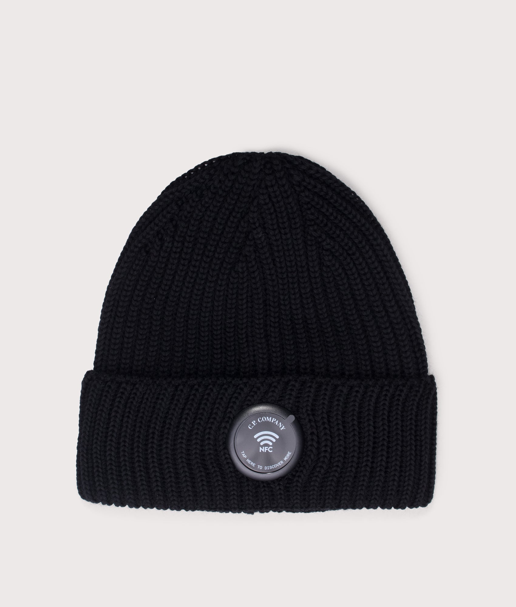 C.P. Company Extrafine Merino Wool Lens Beanie in Black at EQVVS Menswear. NFC Detail shot.