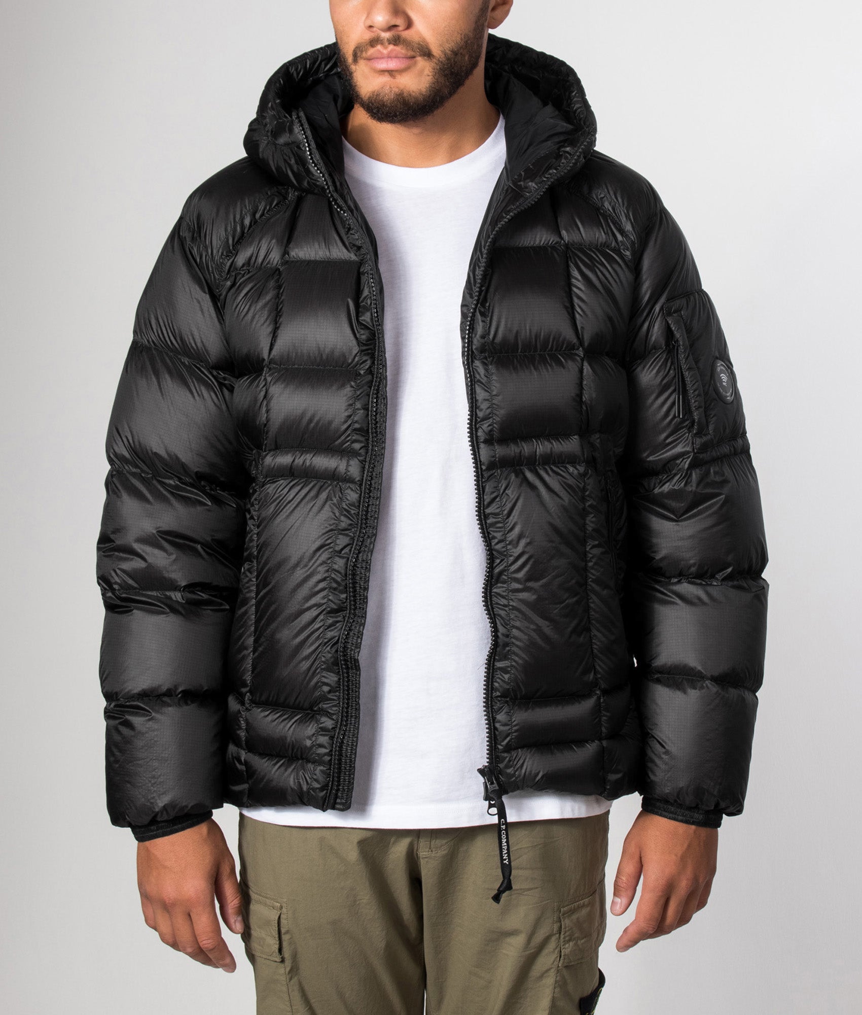 C.P. Company D.D. Shell Hooded Down Jacket in Black at EQVVS Menswear.  Model front shot.