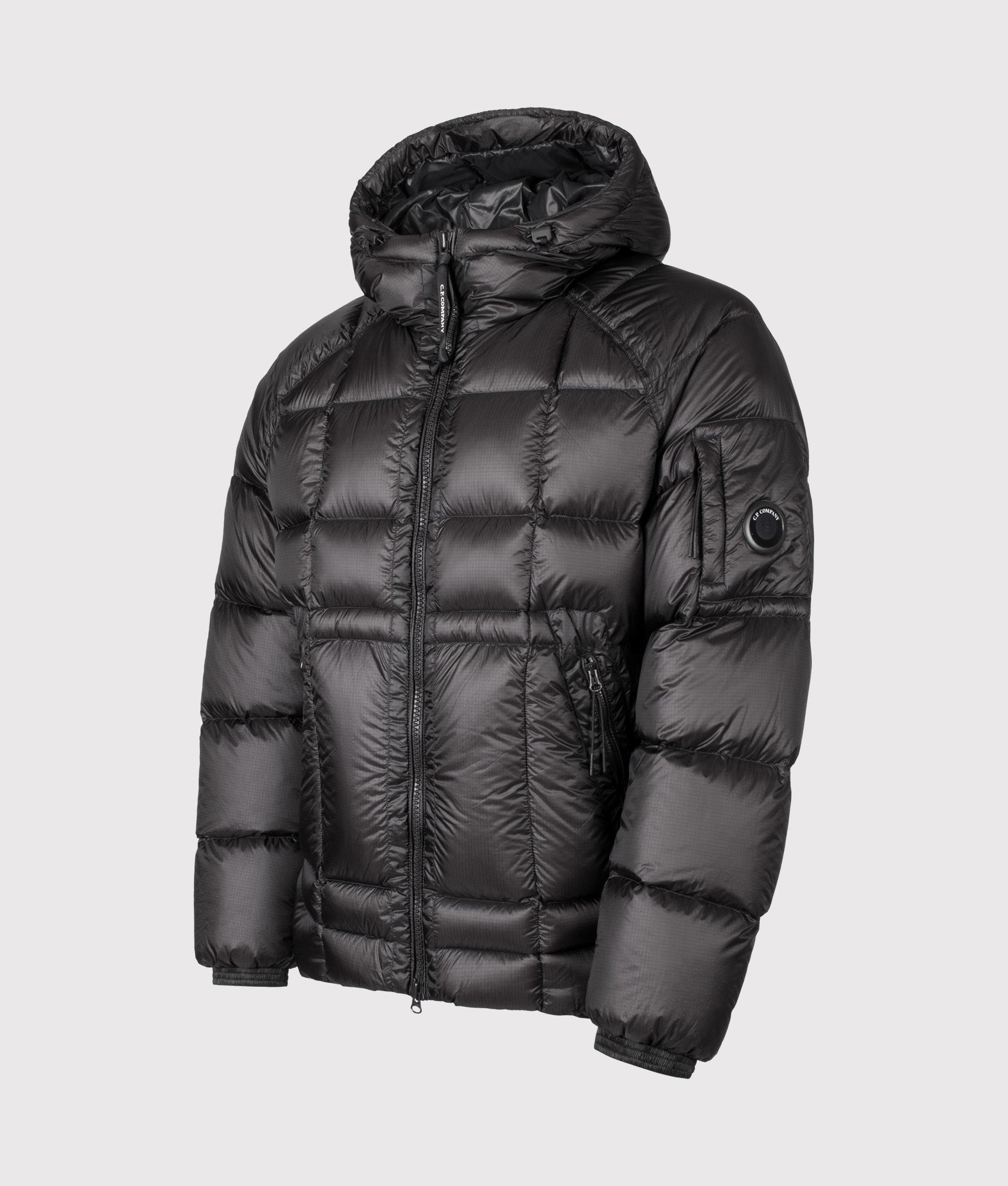 C.P. Company D.D. Shell Hooded Down Jacket in Black at EQVVS Menswear. Angled front shot.