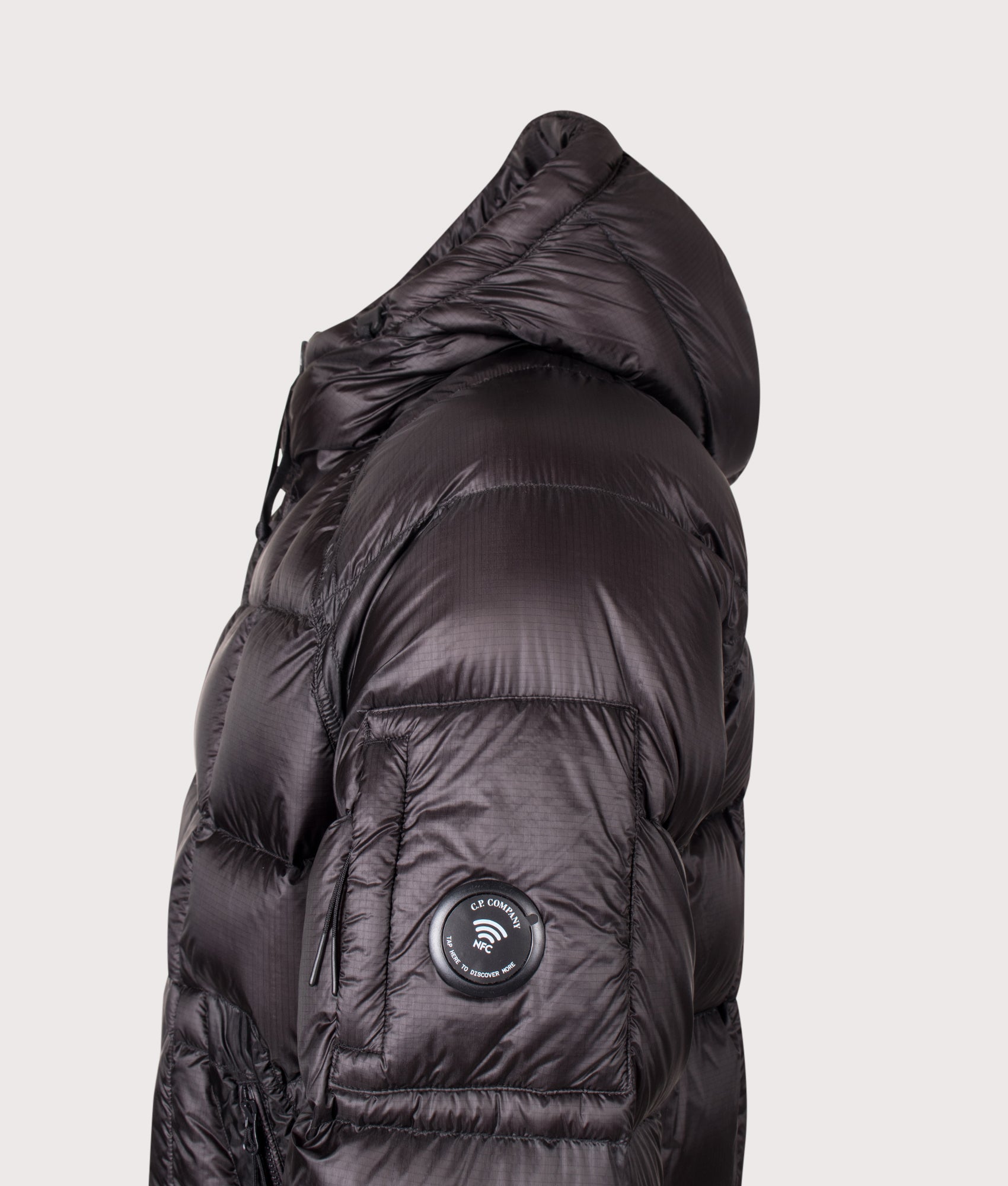 C.P. Company D.D. Shell Hooded Down Jacket in Black at EQVVS Menswear. NFC detail shot.