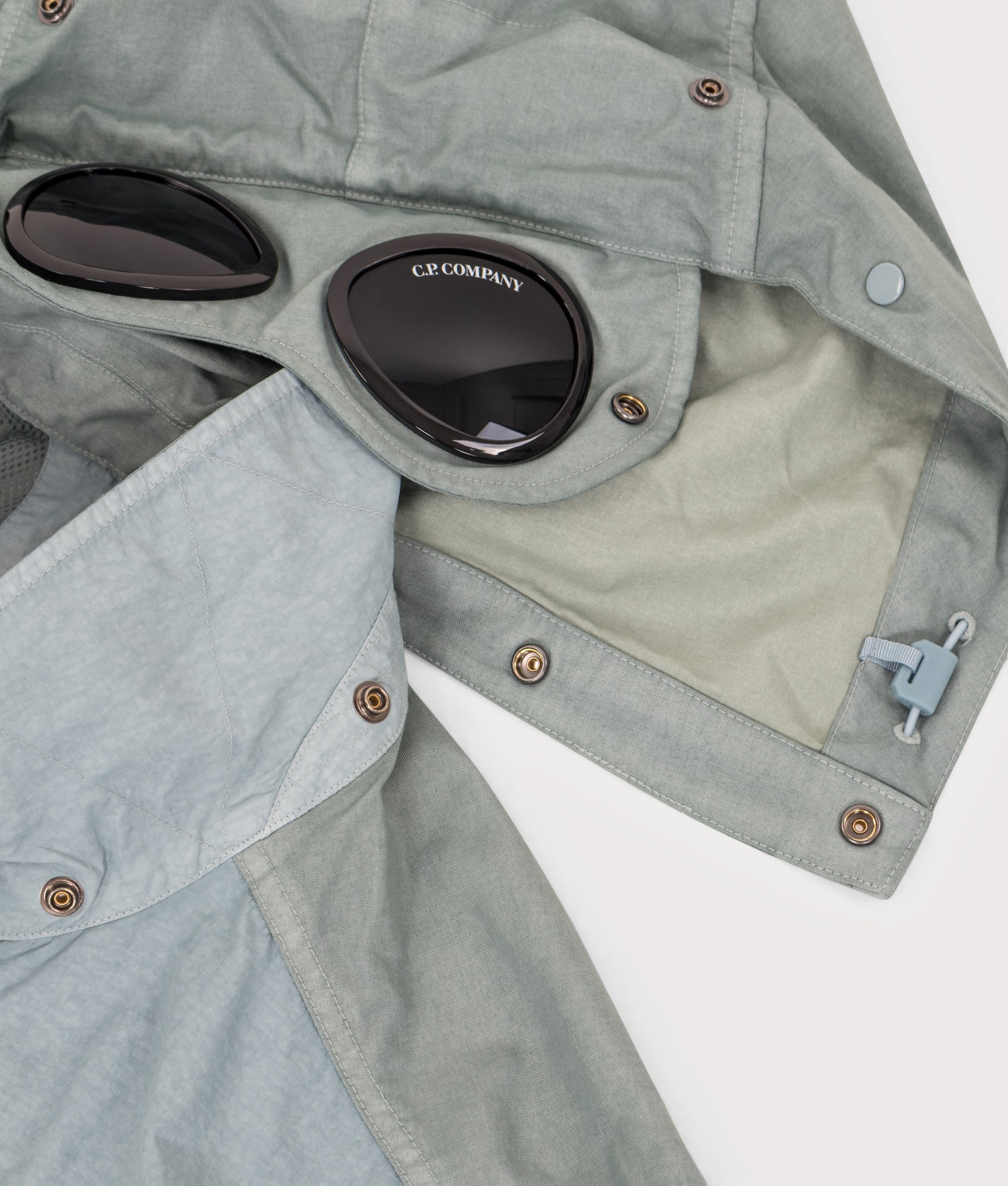 C.P. Company Flatt Nylon Mixed Goggle Overshirt in Silver blue at EQVVS Menswear. Hood detail shot.