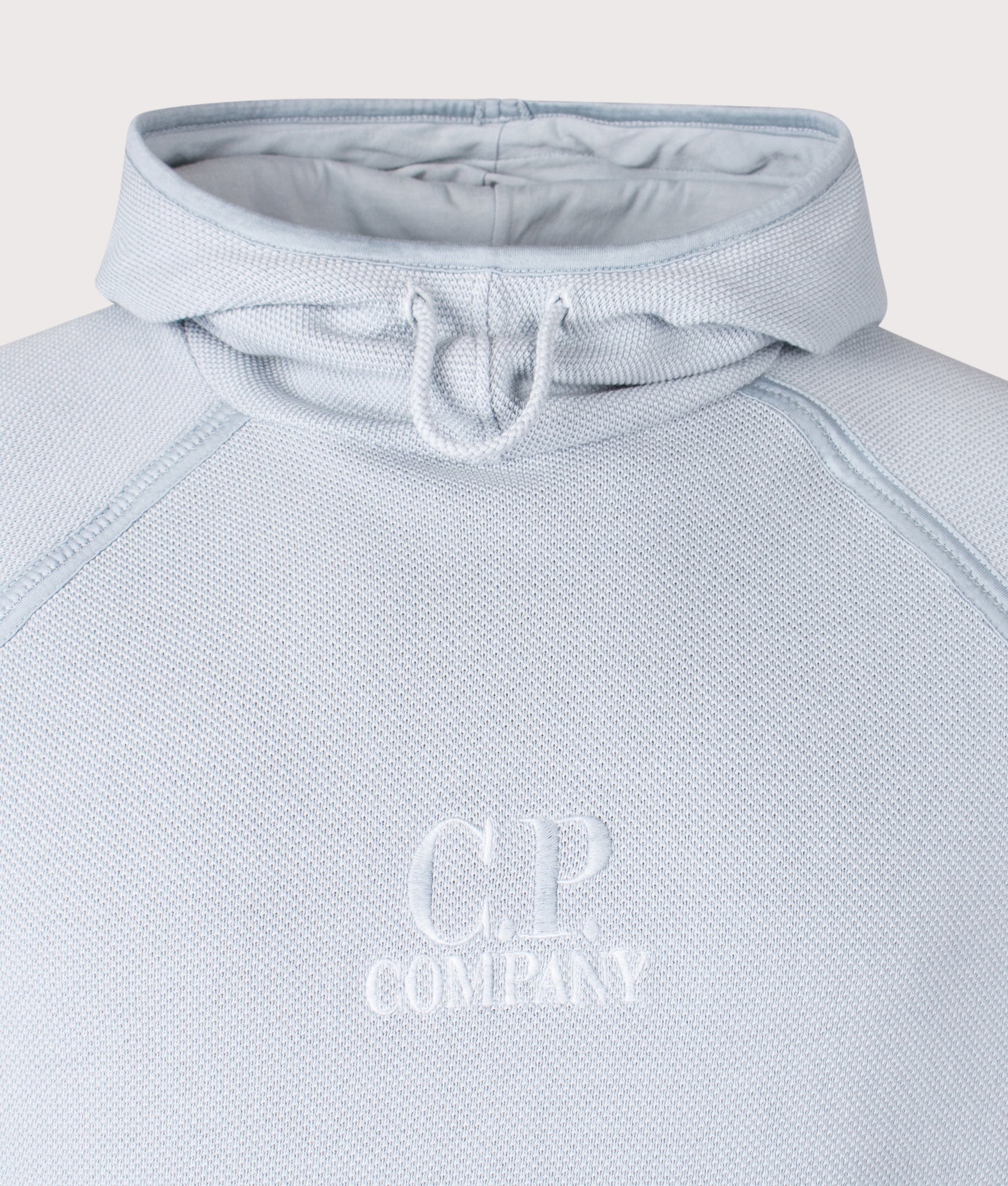 C.P. Company Heavy Piquet Pigment Dyed Hoodie in Silver Blue at EQVVS Menswear. Detail shot.
