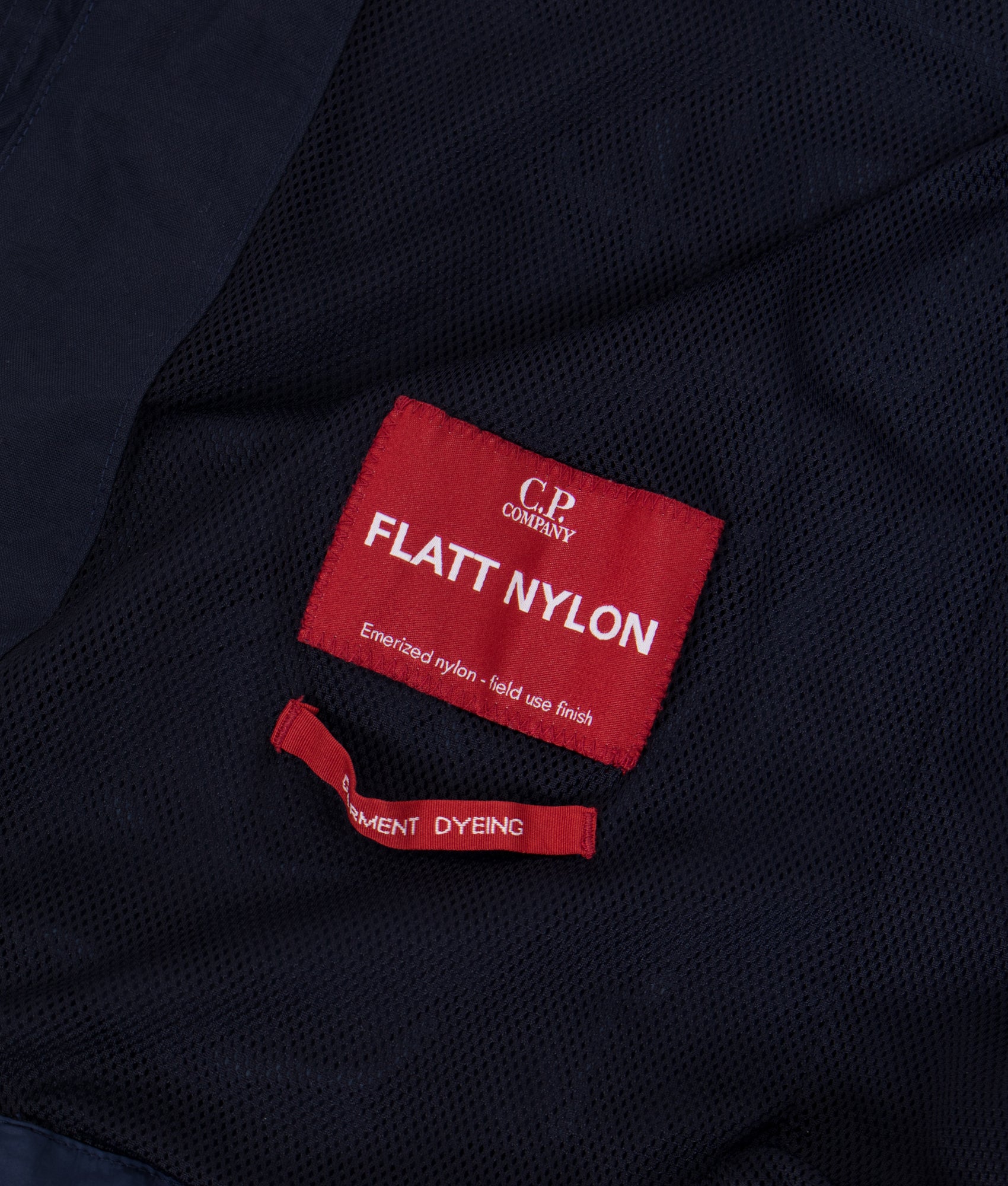 C.P. Company Flatt Nylon Mixed Goggle Overshirt in Midnight Navy at EQVVS Menswear. Label detail shot.