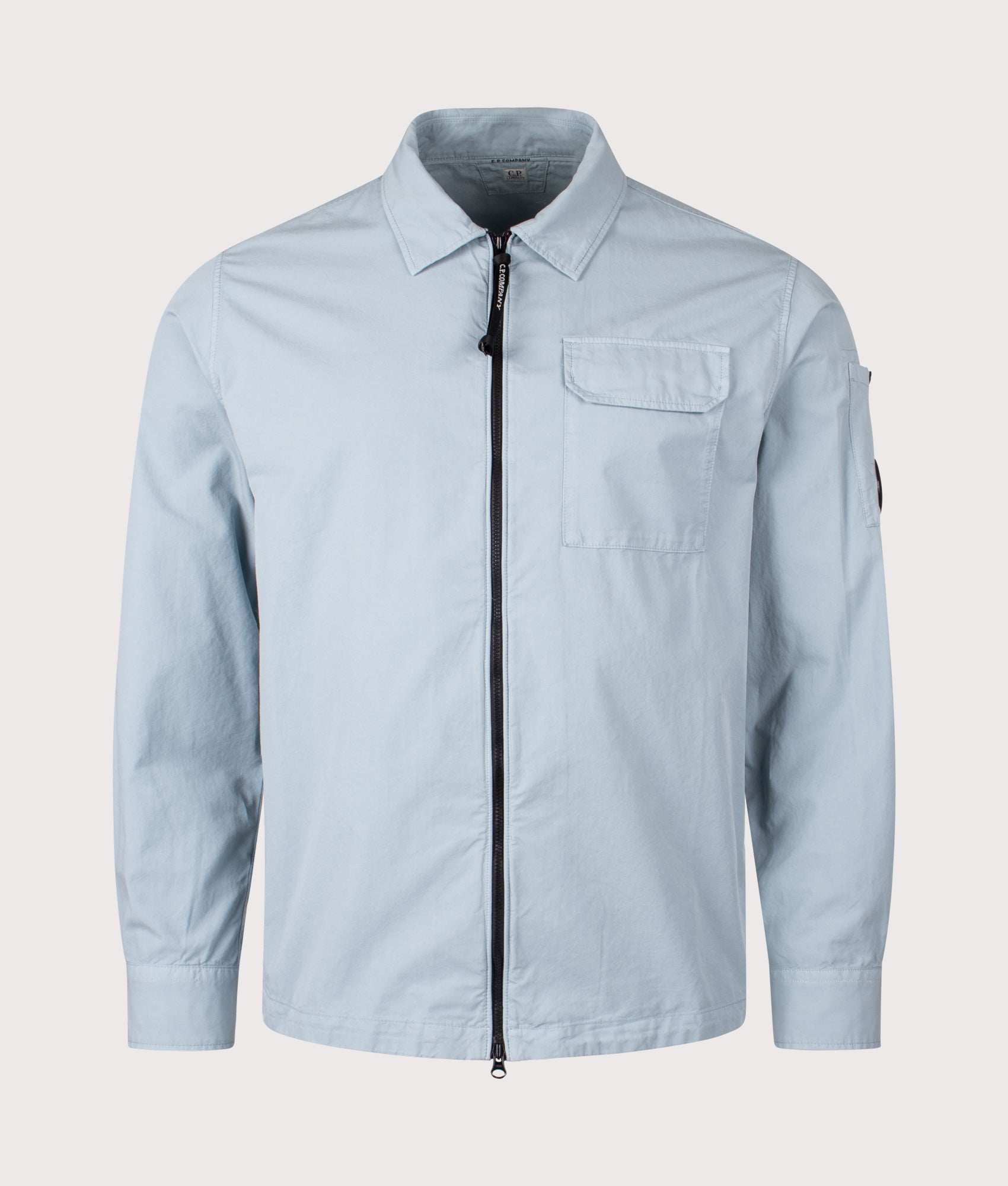 C.P Company Gabardine Zipped Lens Overshirt in Silver Blue at EQVVS Menswear. Front shot.