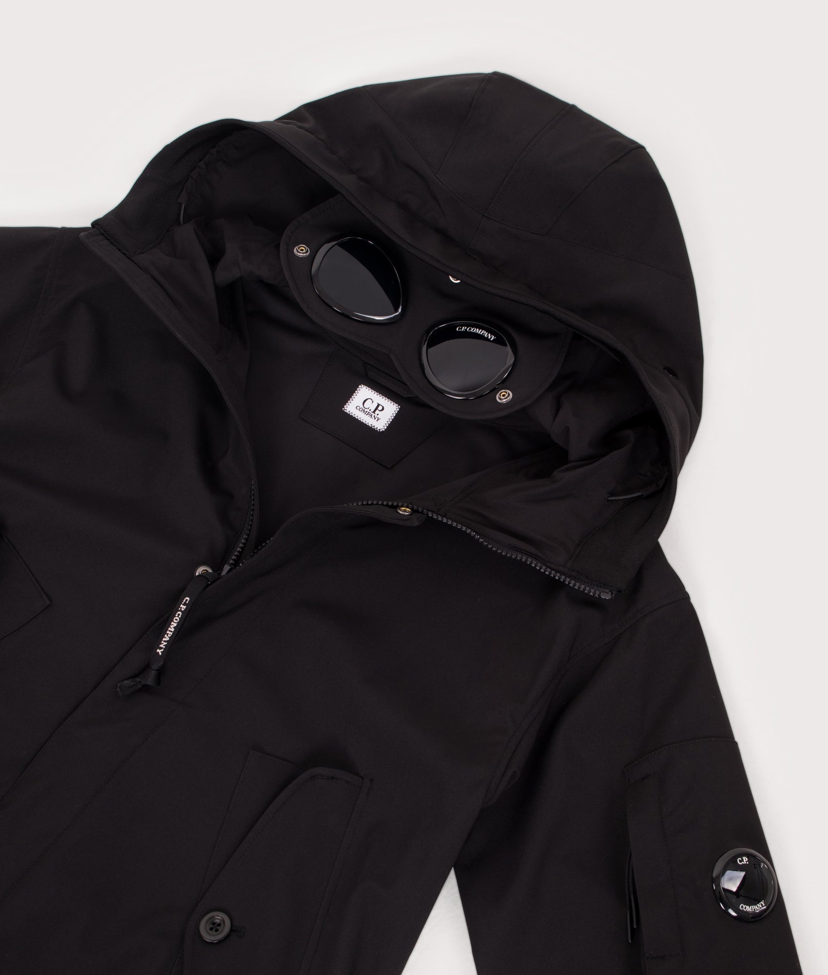 C.P. Company Shell-R Goggle Jacket in Black at EQVVS Menswear. Hood and Goggle shot.