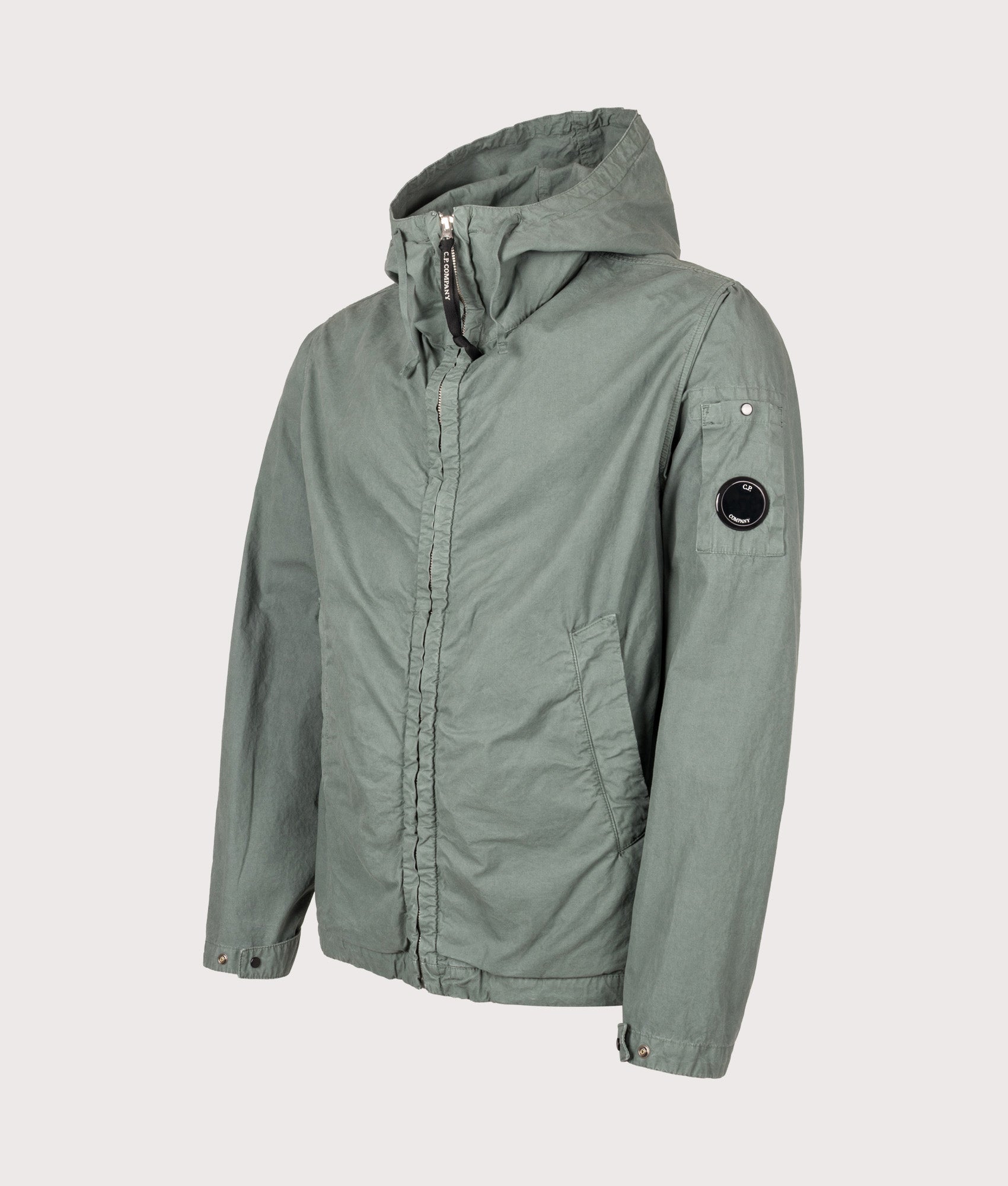 C.P. Company Micro-Reps Hooded Lens Jacket in Laurel Wreath at EQVVS Menswear. Angled front shot.