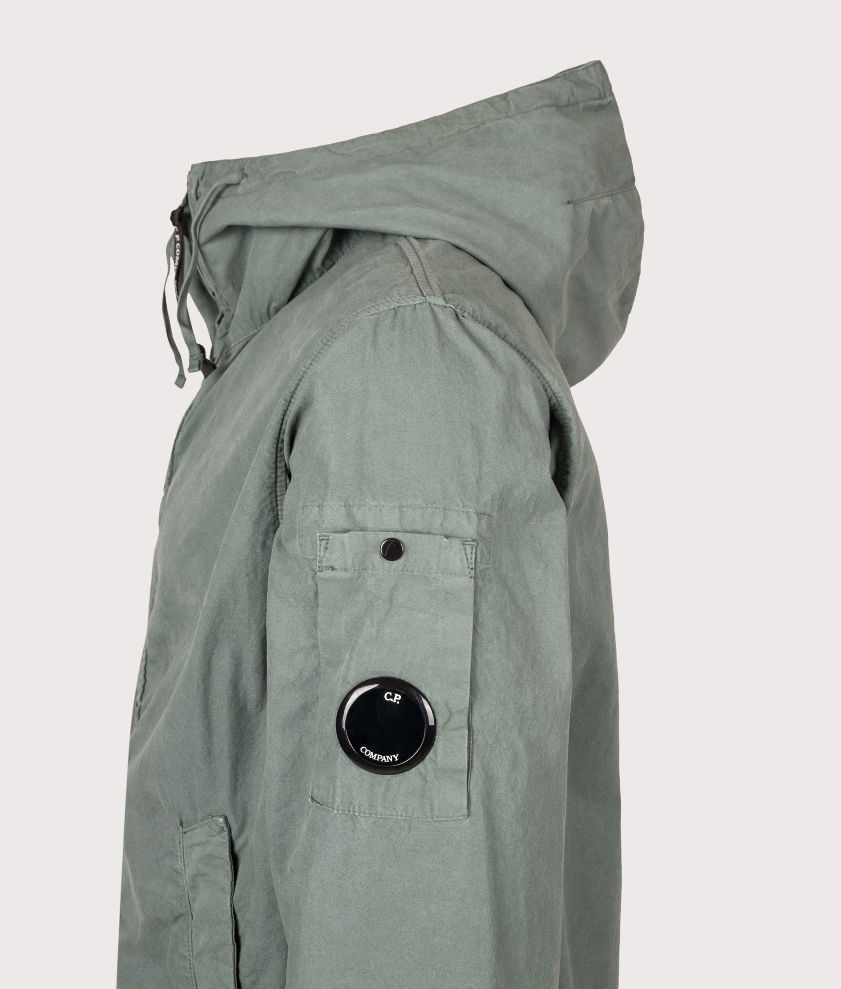 C.P. Company Micro-Reps Hooded Lens Jacket in Laurel Wreath at EQVVS Menswear. Detail shot.