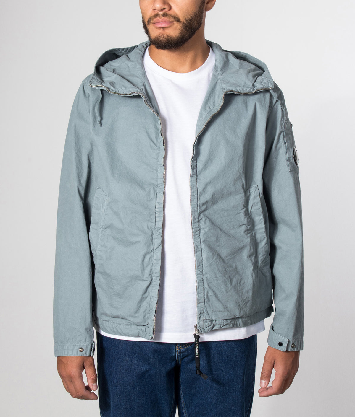 C.P. Company Micro-Reps Hooded Lens Jacket in Silver Blue at EQVVS Menswear. Model front shot.