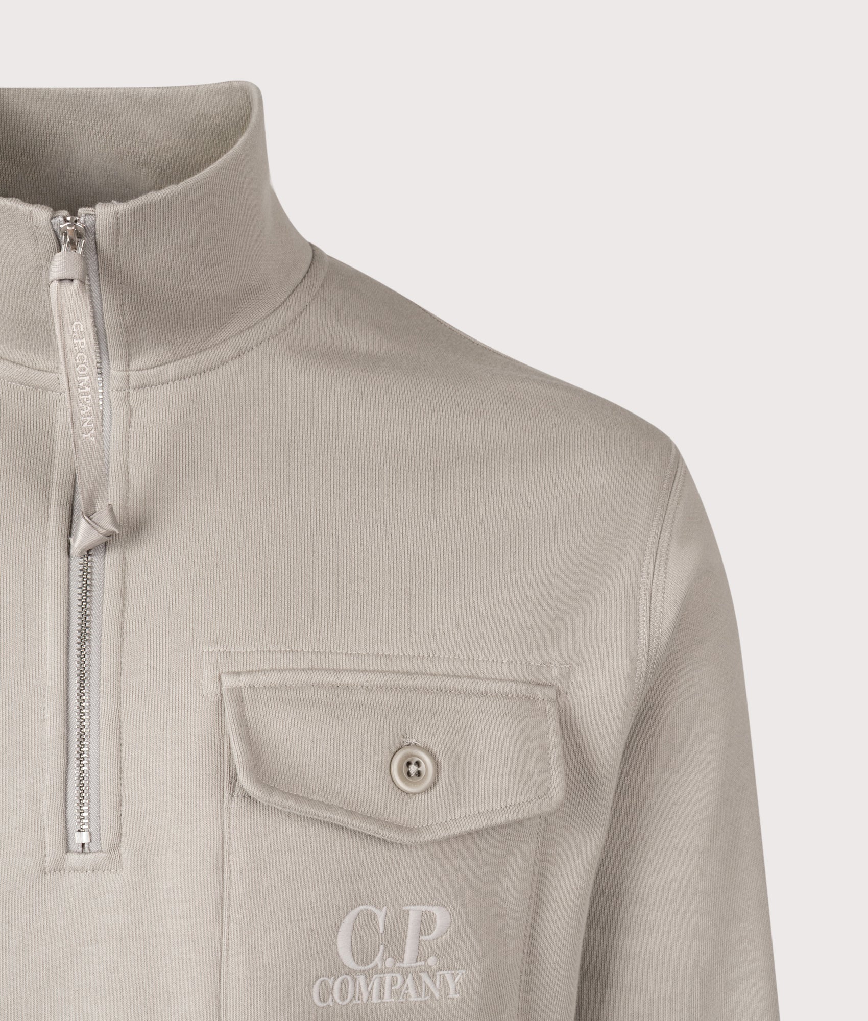 C.P. Company Diagonal Raised Fleece Half Zip Sweatshirt in Dove at EQVVS Menswear. Detail shot.