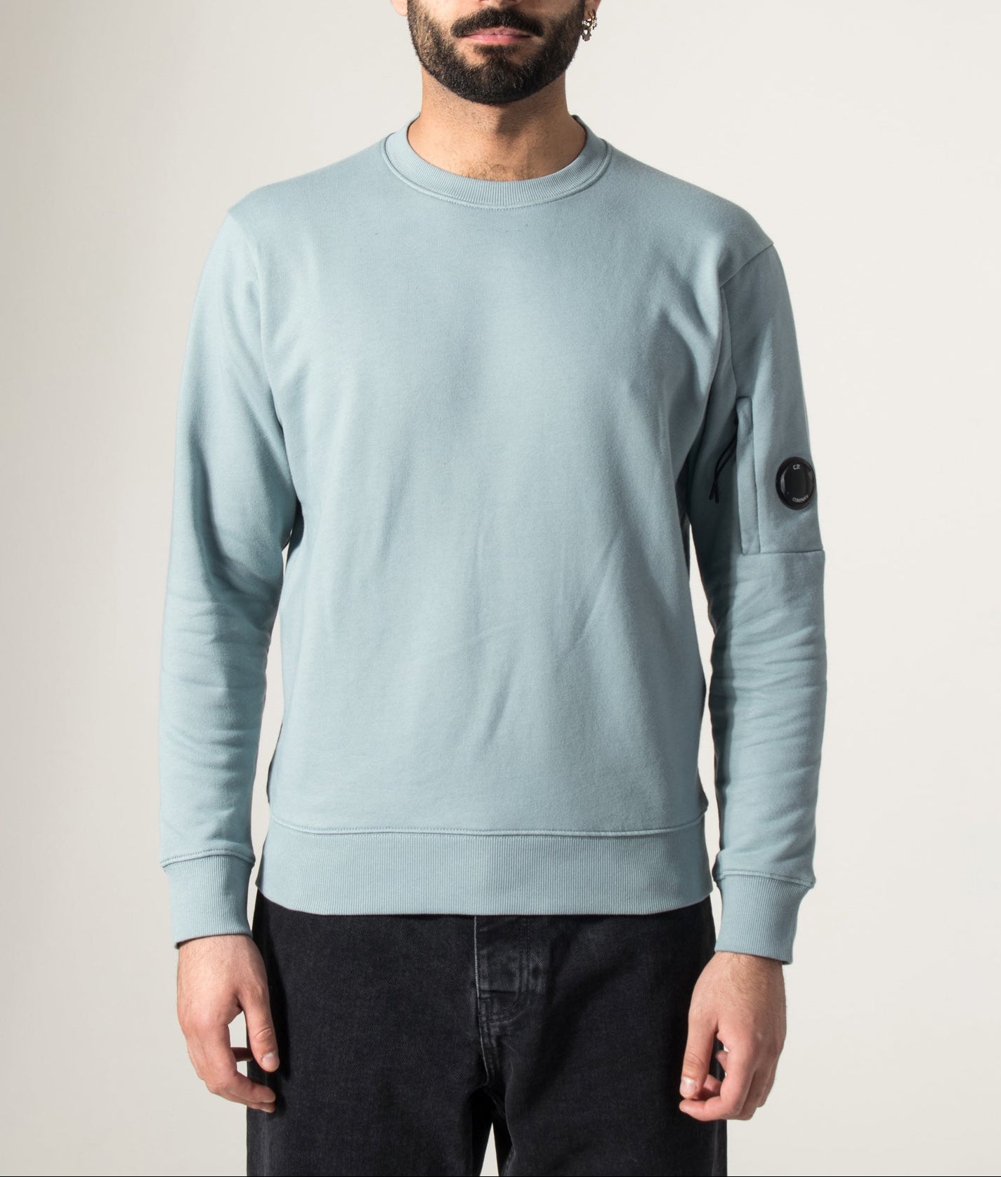 C.P. Company Diagonal Raised Fleece Lens Sweatshirt in Silver Blue at EQVVS Menswear. Model front shot.