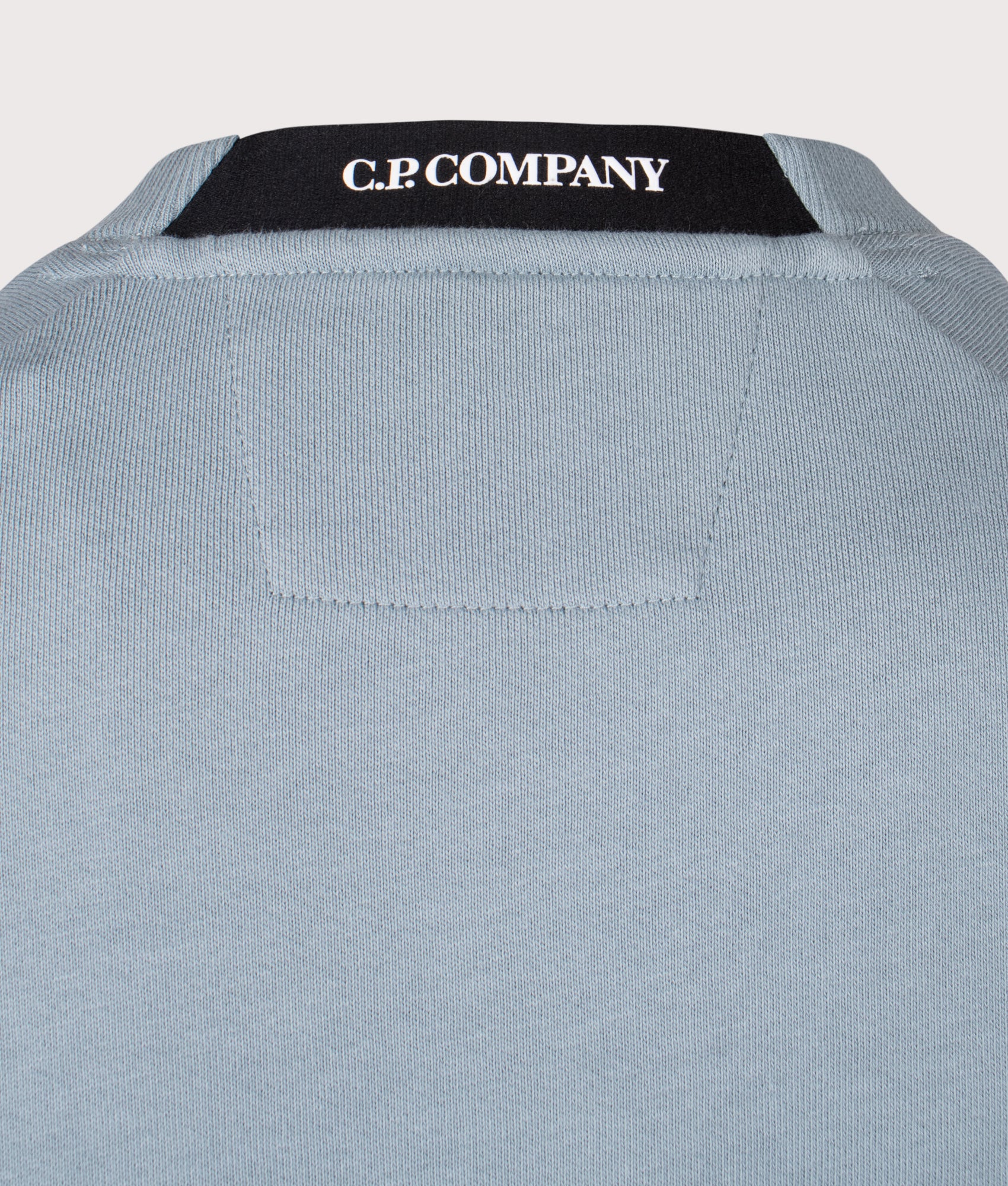 C.P. Company Diagonal Raised Fleece Lens Sweatshirt in Silver Blue at EQVVS Menswear. Back shot.