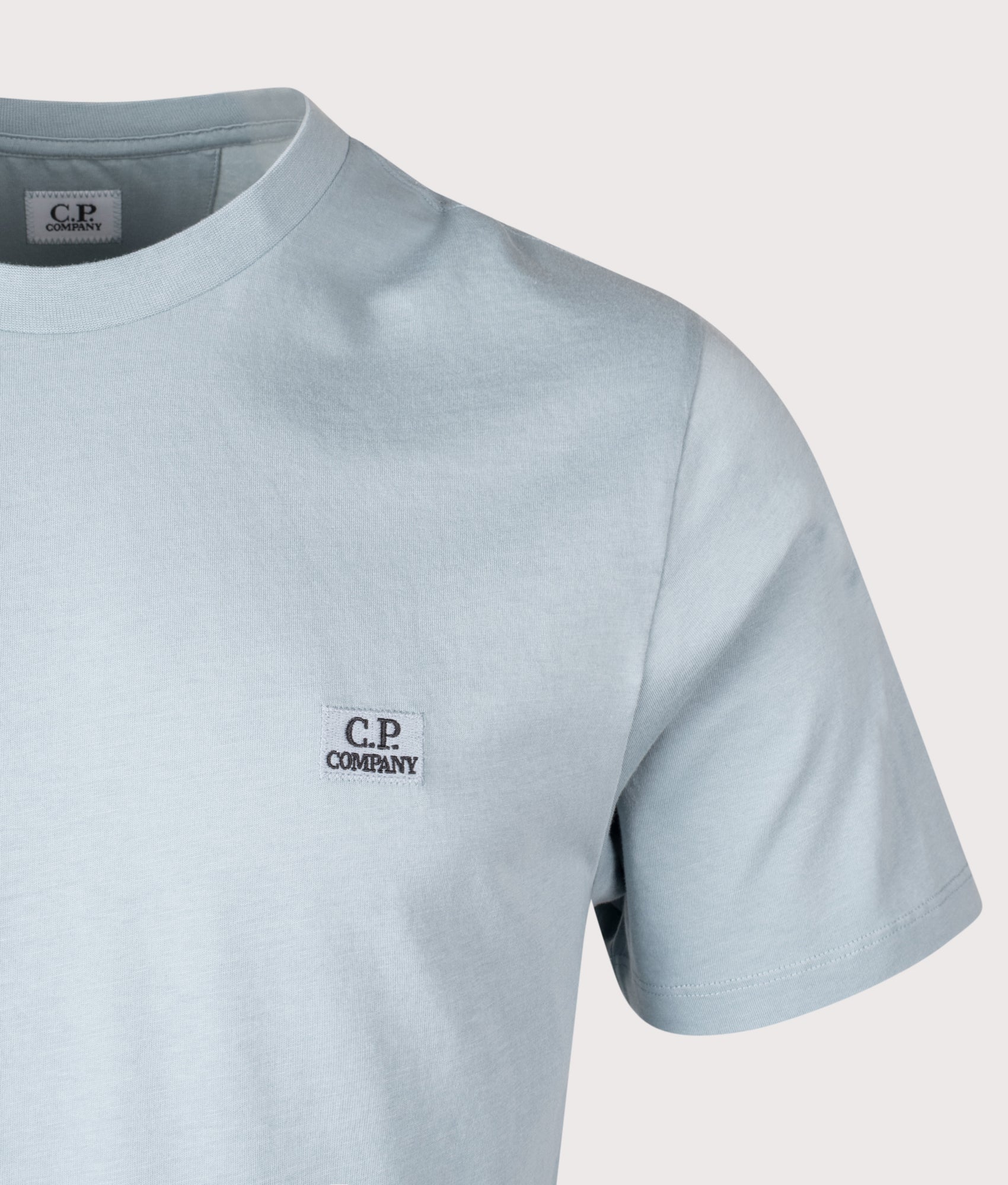 C.P. Company Jersey Logo Patch T-Shirt in Silver Blue at EQVVS Menswear. Detail shot.