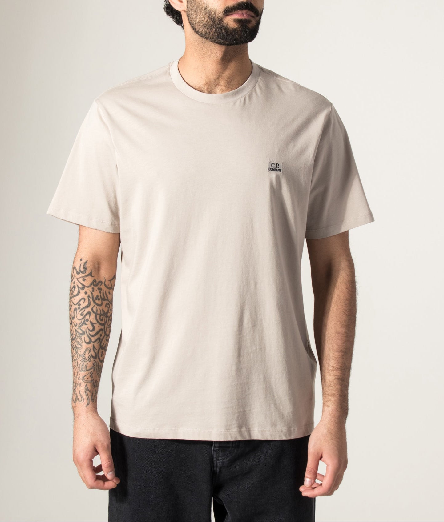 C.P. Company 30/1 Jersey Short Sleeve Logo Patch T-Shirt in Dove at EQVVS Menswear. Model front shot.