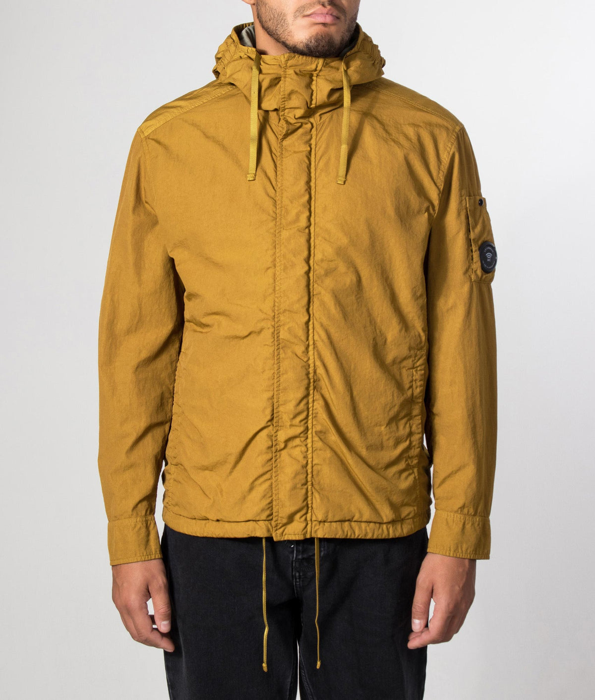 C.P. Company T-ST Nylon Hooded Lens Overshirt in Buck Thorn Brown at EQVVS Menswear. Model front shot.