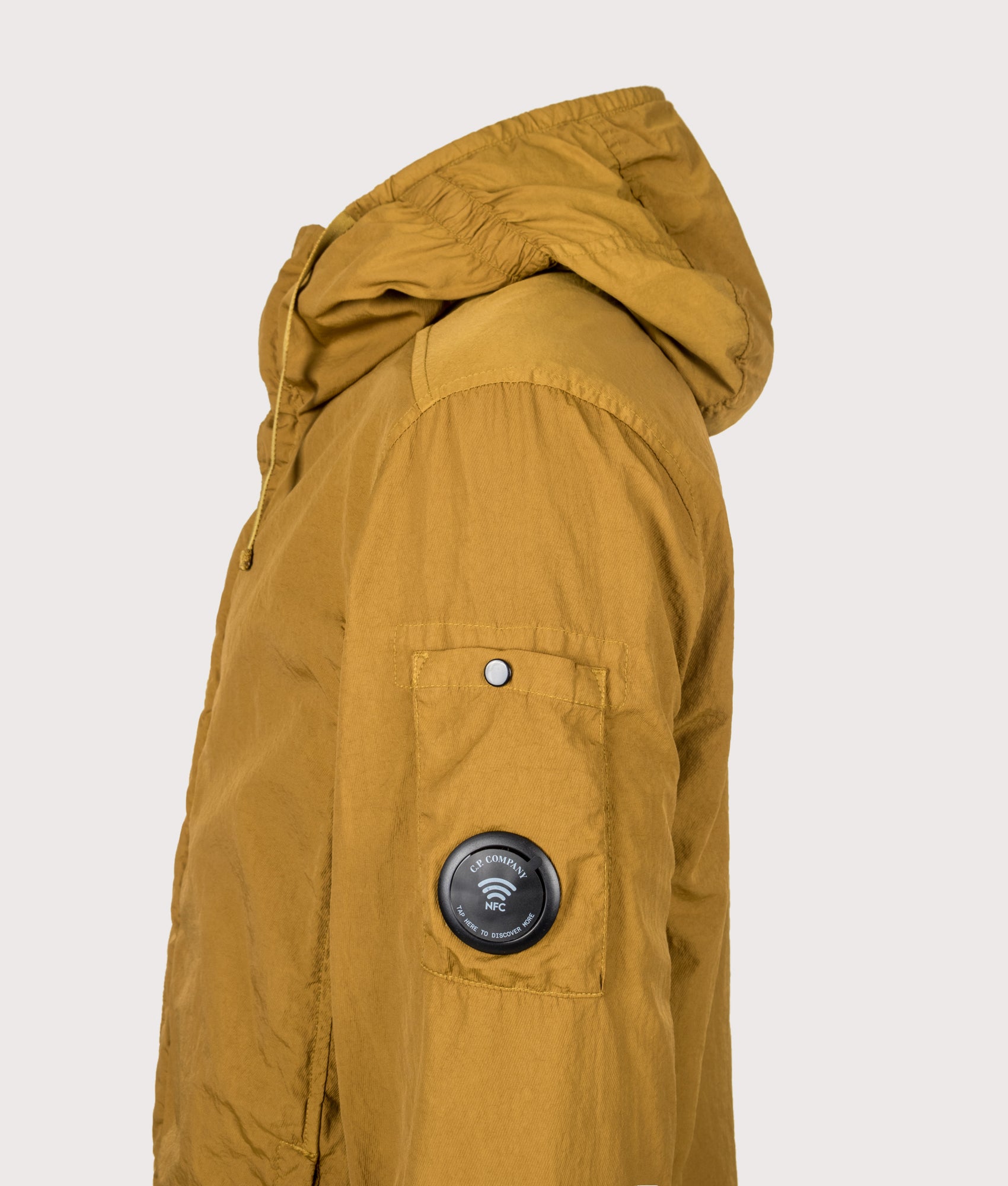 C.P. Company T-ST Nylon Hooded Lens Overshirt in Buck Thorn Brown at EQVVS Menswear. Side detail shot.