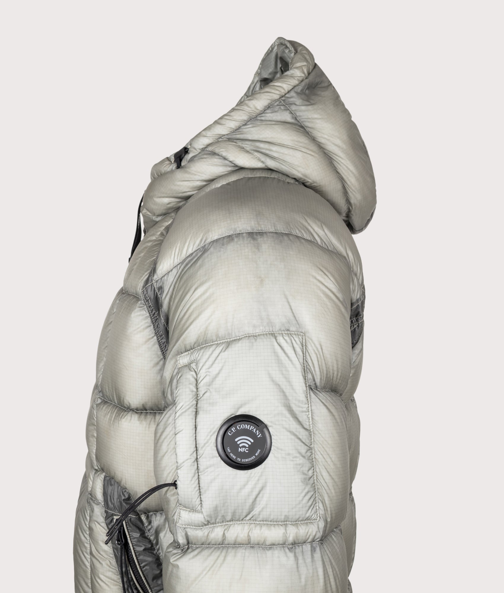 C.P. Company D.D. Shell Hooded Down Jacket in Flint Grey at EQVVS Menswear.  Detail NFC shot.