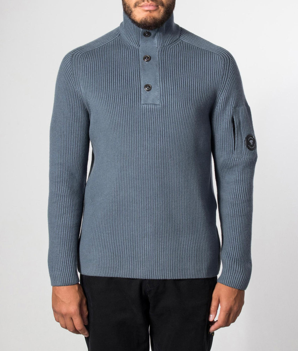 C.P. Company Full Rib Cotton Half Button Lens Jumper in Orion Blue at EQVVS Menswear. Model front shot.
