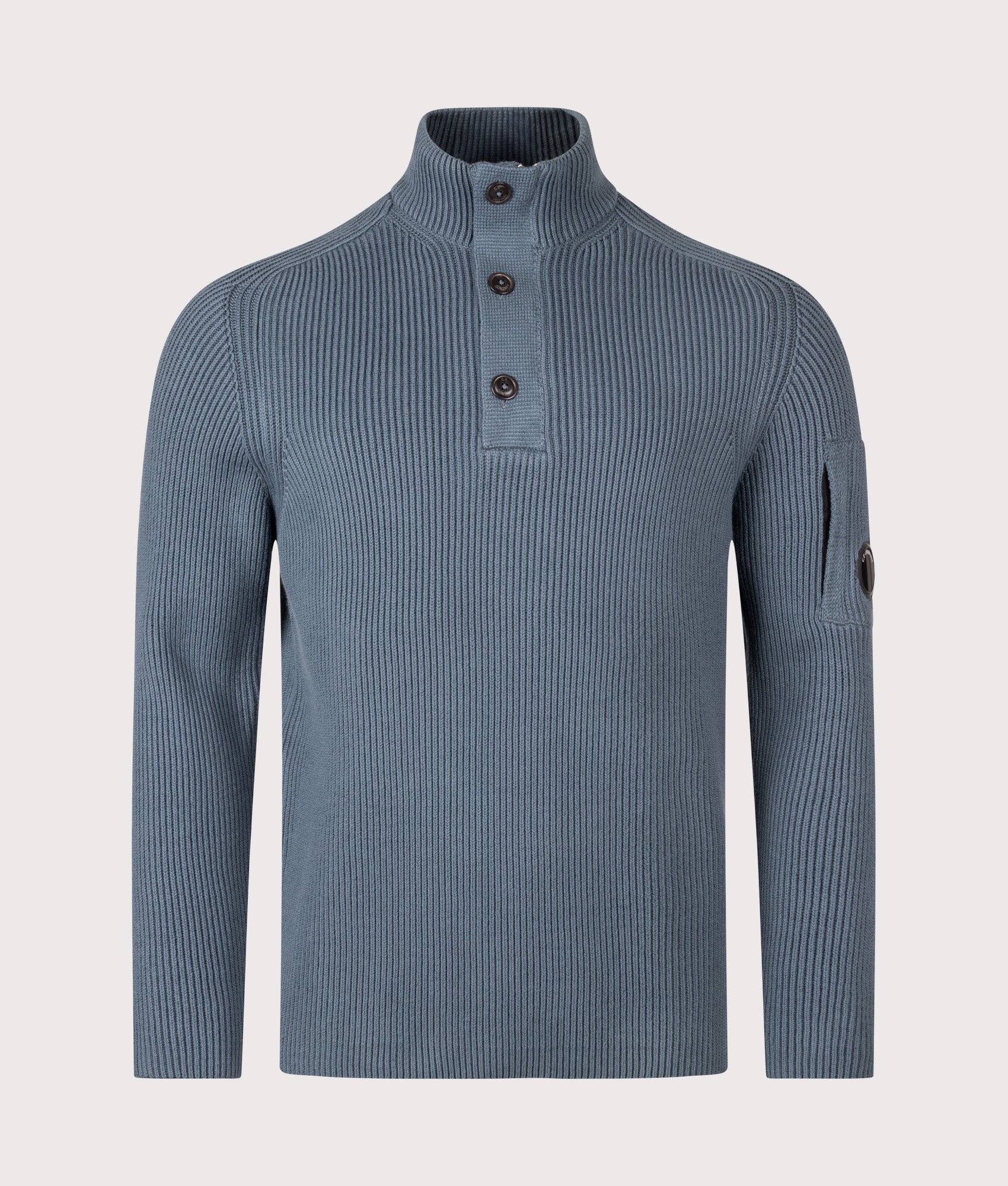 C.P. Company Full Rib Cotton Half Button Lens Jumper in Orion Blue at EQVVS Menswear. Front shot.