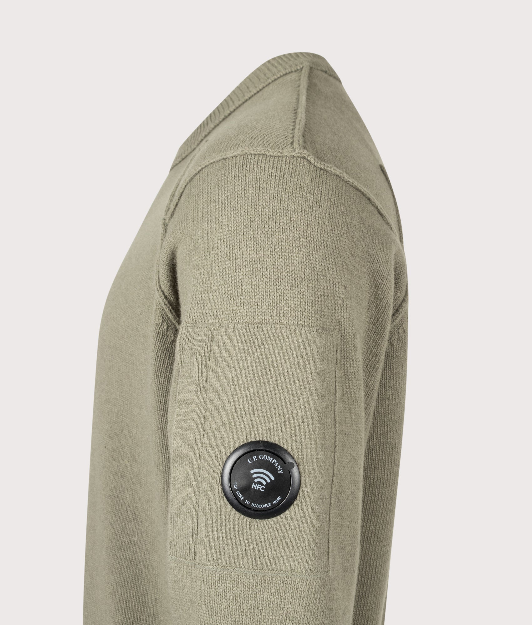 C.P. Company Lambswool GRS Crewneck Lens Jumper in Fallen Rock at EQVVS Menswear. NFC Detail shot.