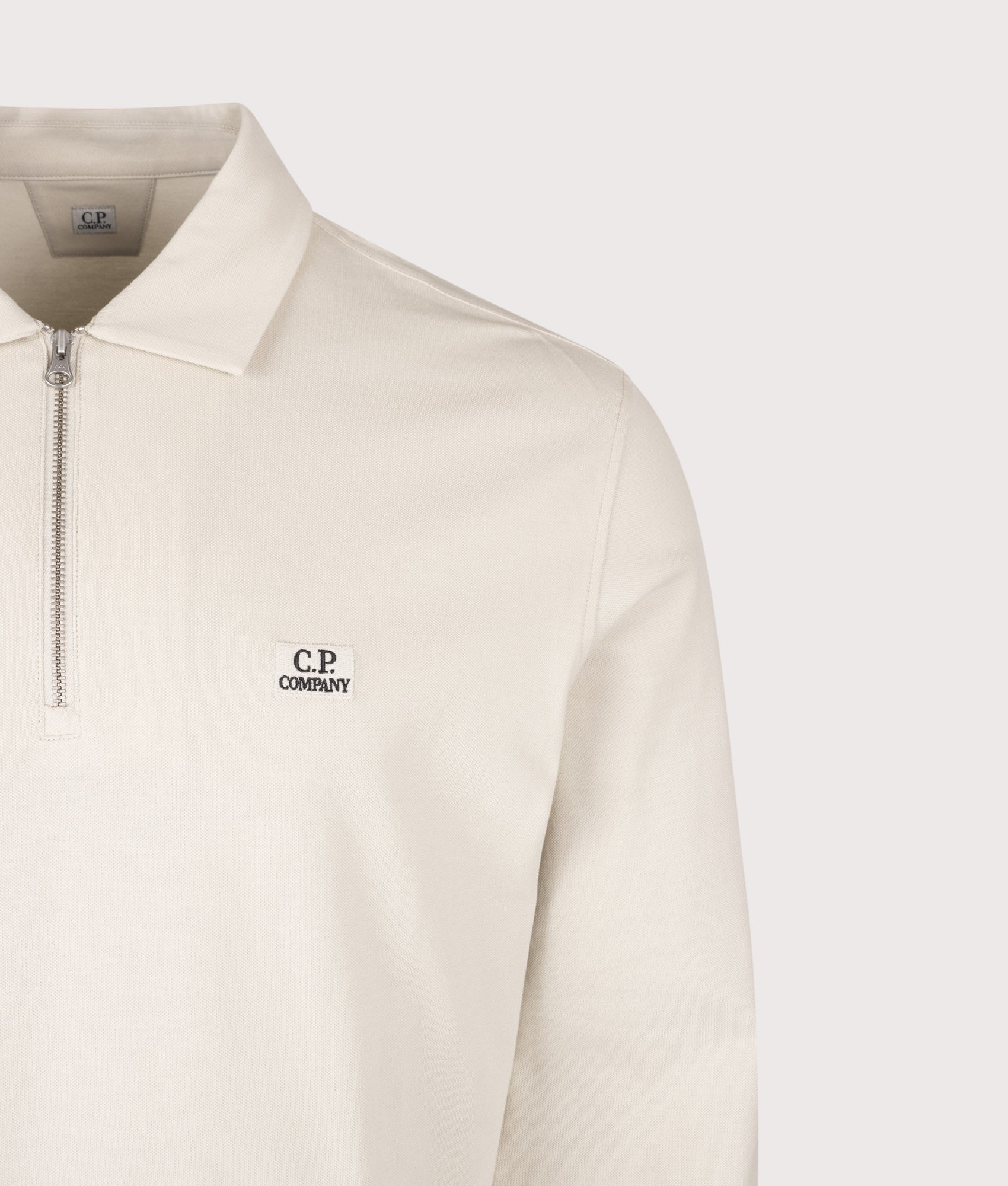 C.P. Company Long Sleeve Stretch Piquet Zip Polo Shirt in Silver Birch at EQVVS Menswear. Detail shot.