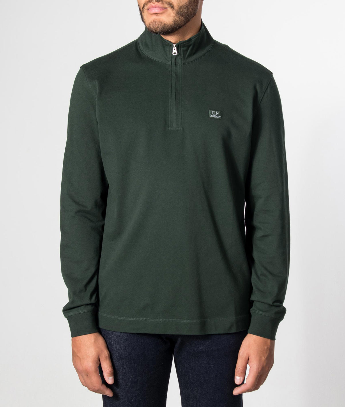 C.P. Company Stretch Piquet Quarter Zip Sweatshirt in Ponderosa Pine at EQVVS Menswear. Model front shot.