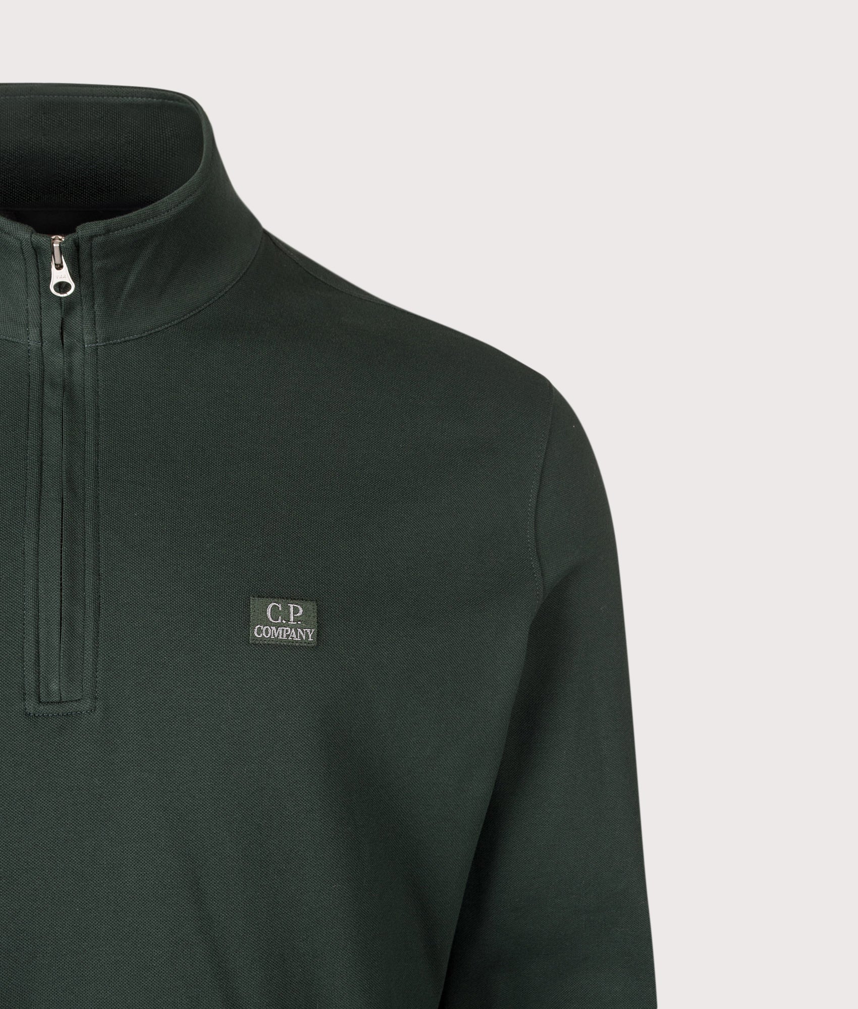 C.P. Company Stretch Piquet Quarter Zip Sweatshirt in Ponderosa Pine at EQVVS Menswear. Detail shot.