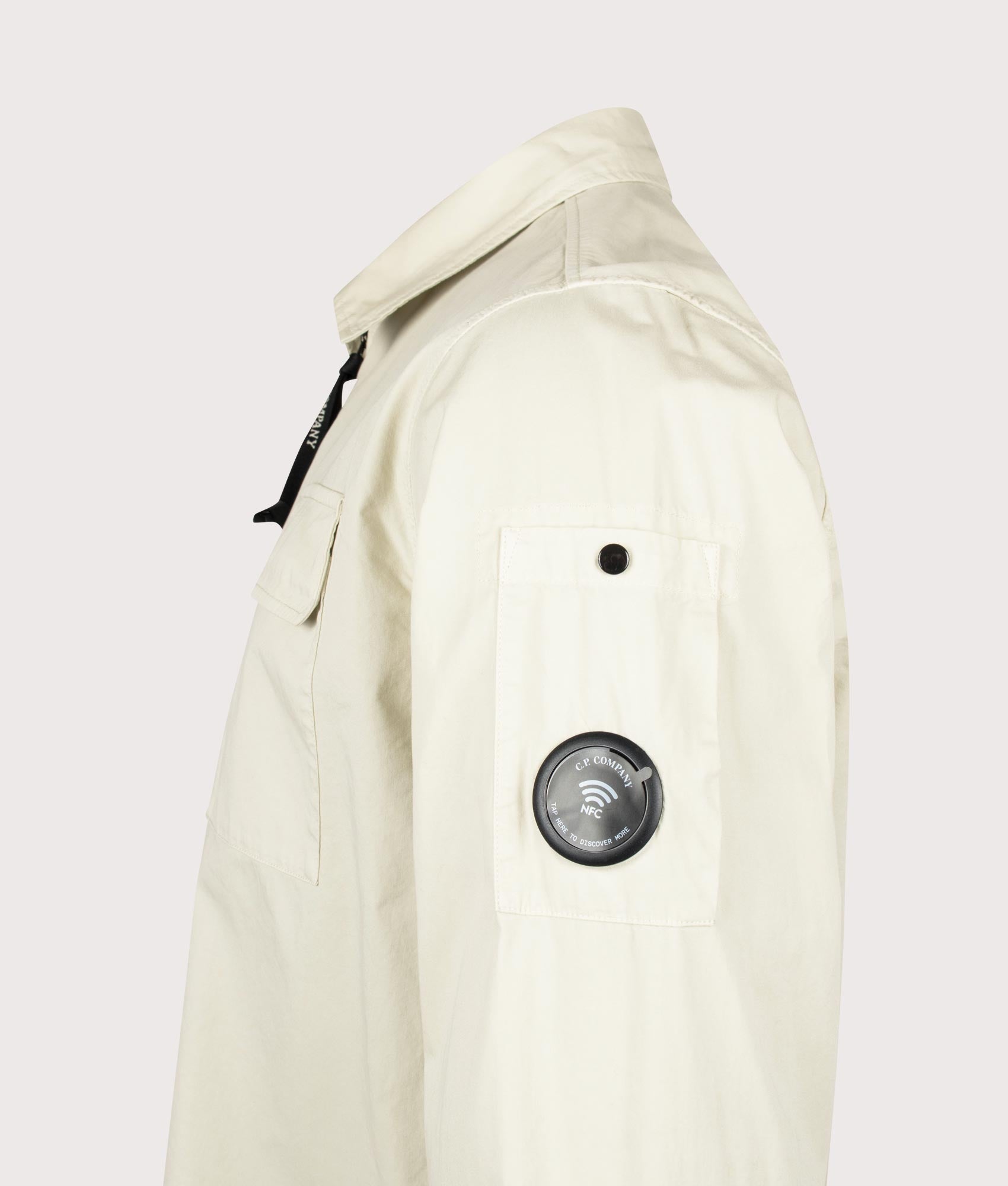 C.P. Company Organic Gabardine Zipped Lens Overshirt in Silver Birch at EQVVS Menswear. NFC detail shot.