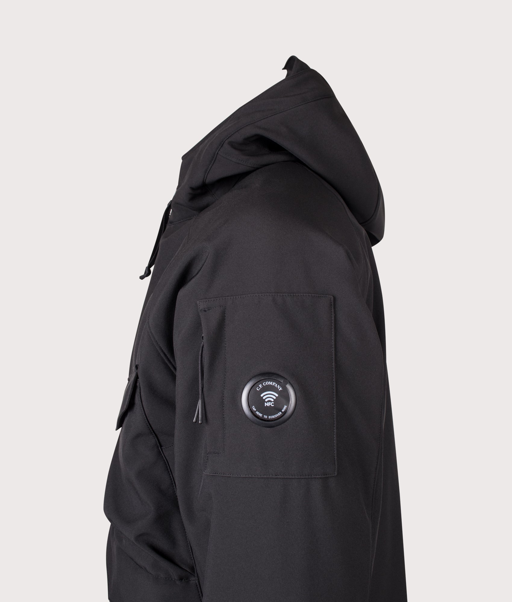 C.P. Company C.P. Shell-R Padded Hooded Lens Jacket in Black at EQVVS Menswear. NFC detail shot.