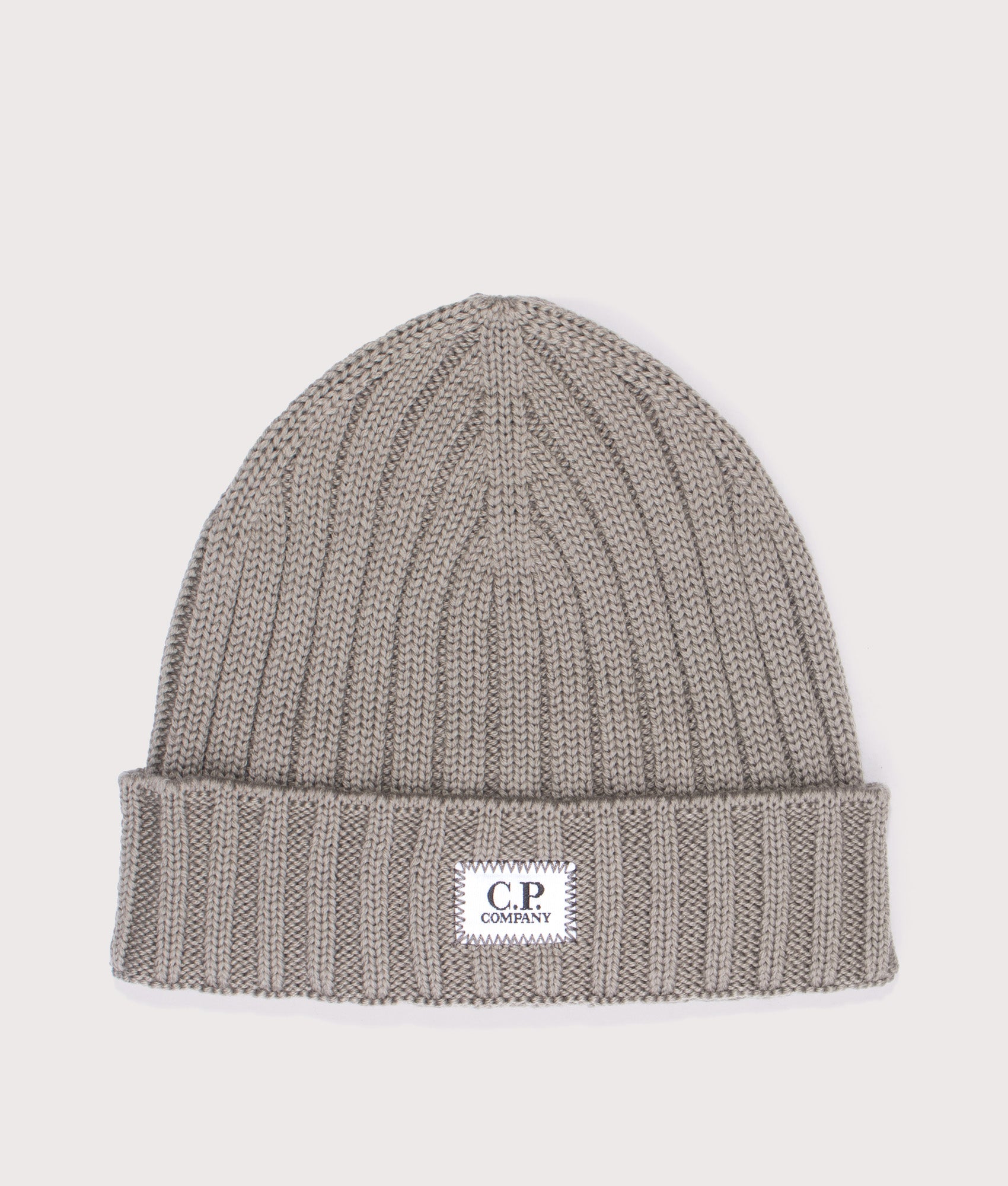 C.P. Company Extrafine Merino Wool Logo Beanie in Fallen Rock at EQVVS Menswear. Front shot.