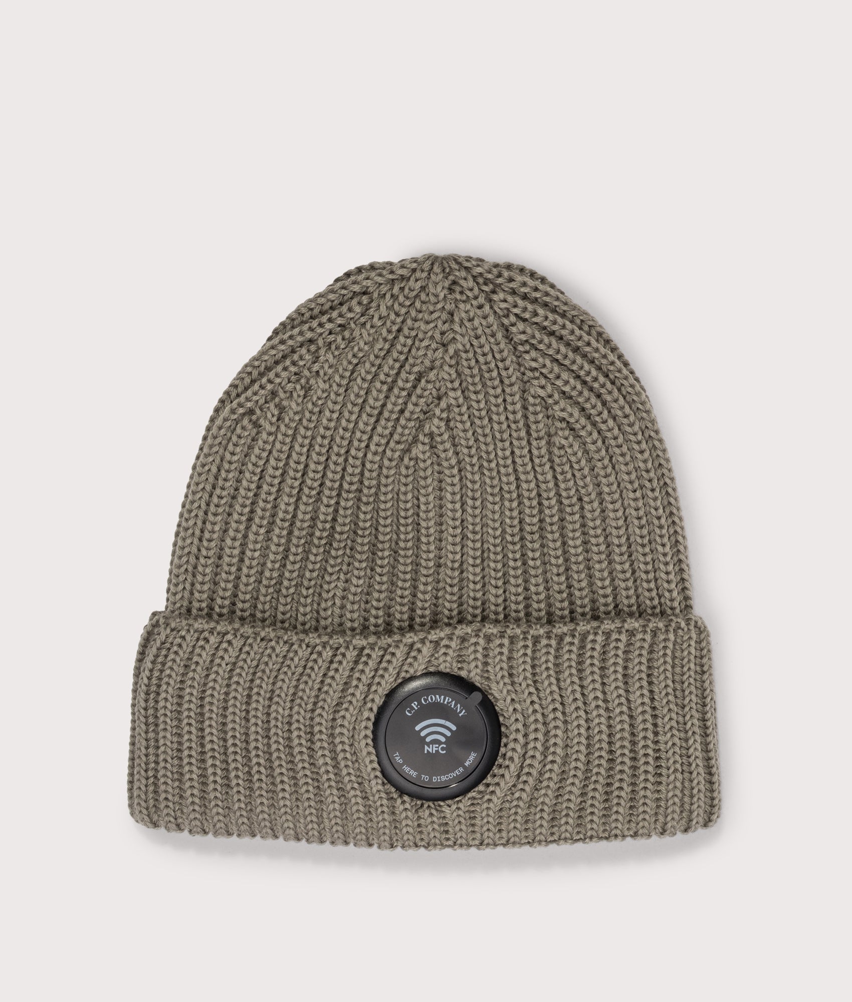 C.P. Company Extrafine Merino Wool Lens Beanie in Fallen Rock at EQVVS Menswear. NFC Detail shot.
