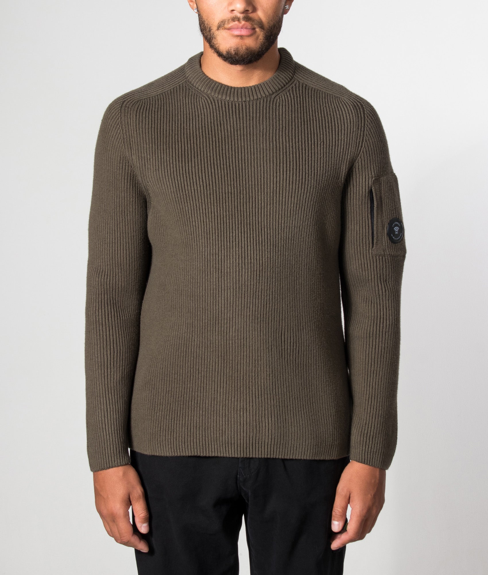 C.P. Company Full Rib Cotton Crewneck Lens Jumper in Ivy Green at EQVVS Menswear. Model front shot.