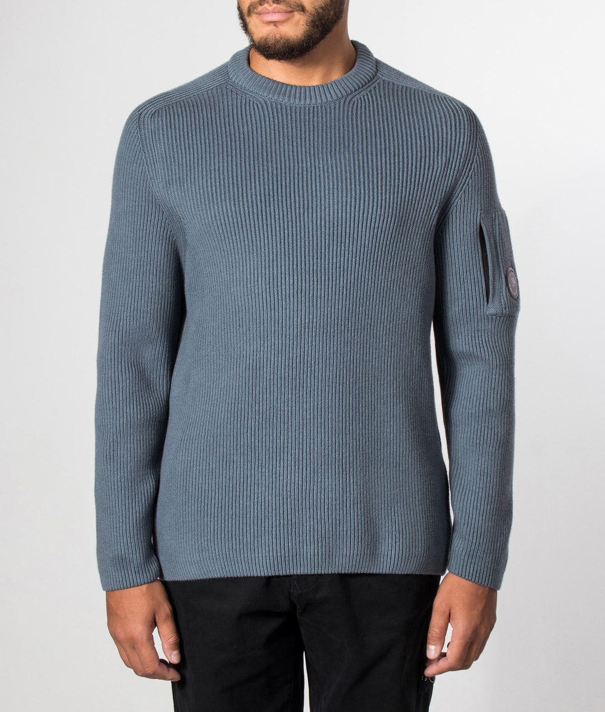C.P. Company Full Rib Cotton Crewneck Lens Jumper in Orion Blue at EQVVS Menswear. Model front shot.