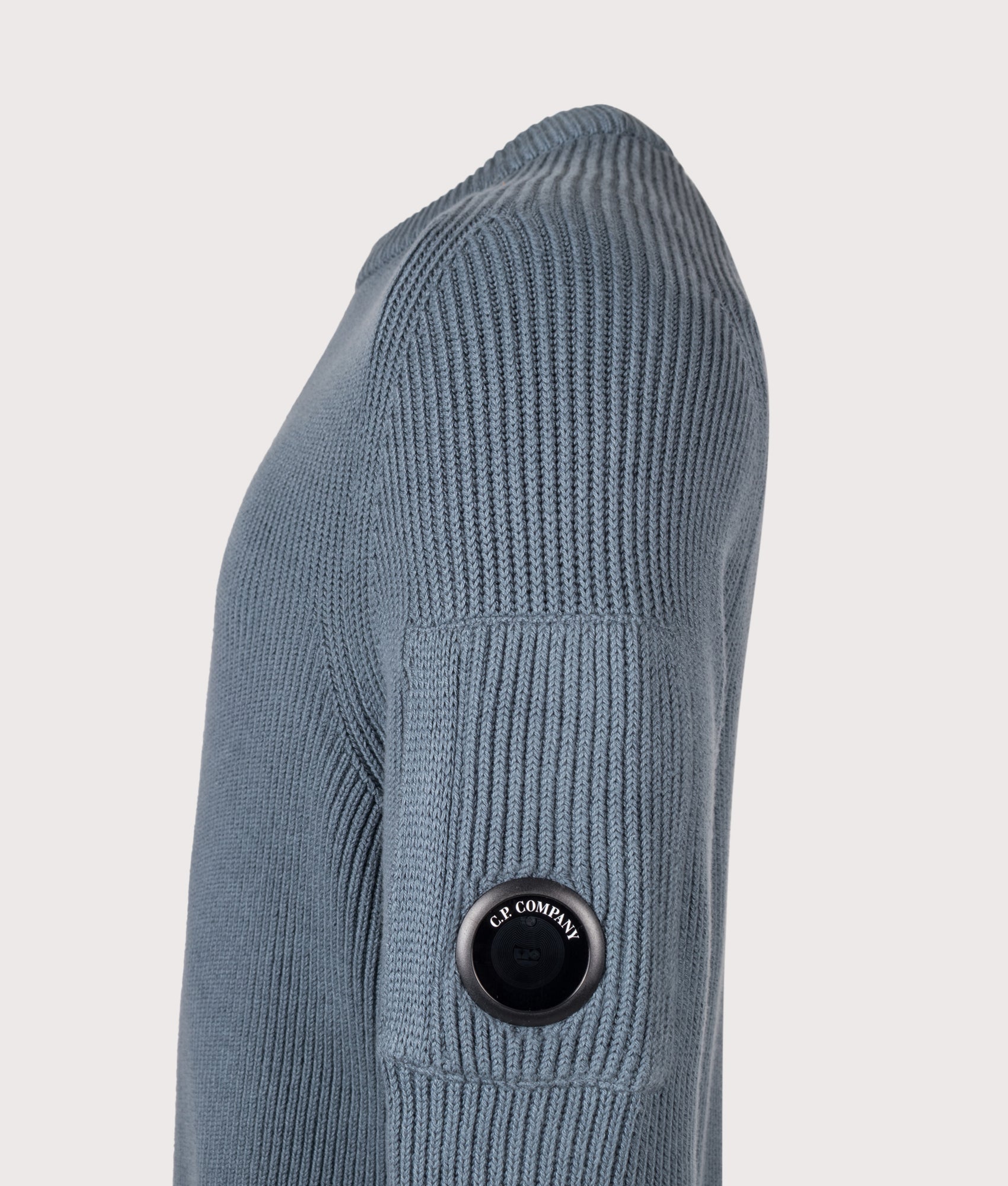 C.P. Company Full Rib Cotton Crewneck Lens Jumper in Orion Blue at EQVVS Menswear. Detail shot.