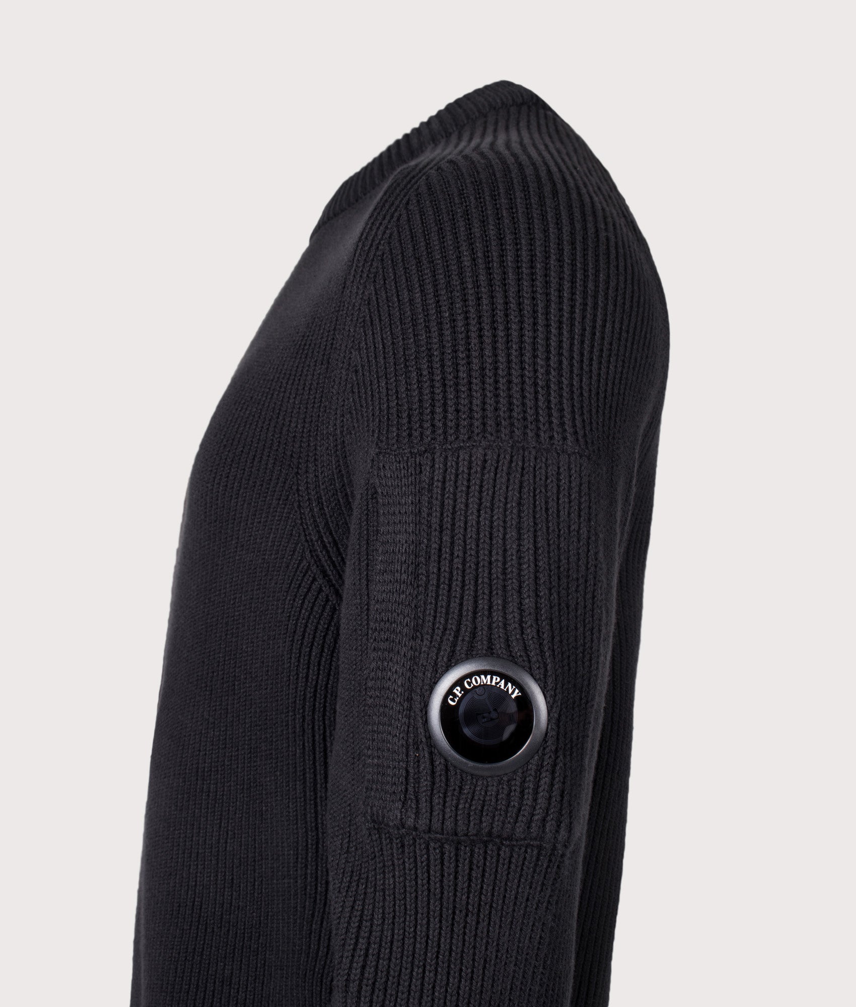 C.P. Company Full Rib Cotton Crewneck Lens Jumper in Black at EQVVS Menswear. Detail shot.
