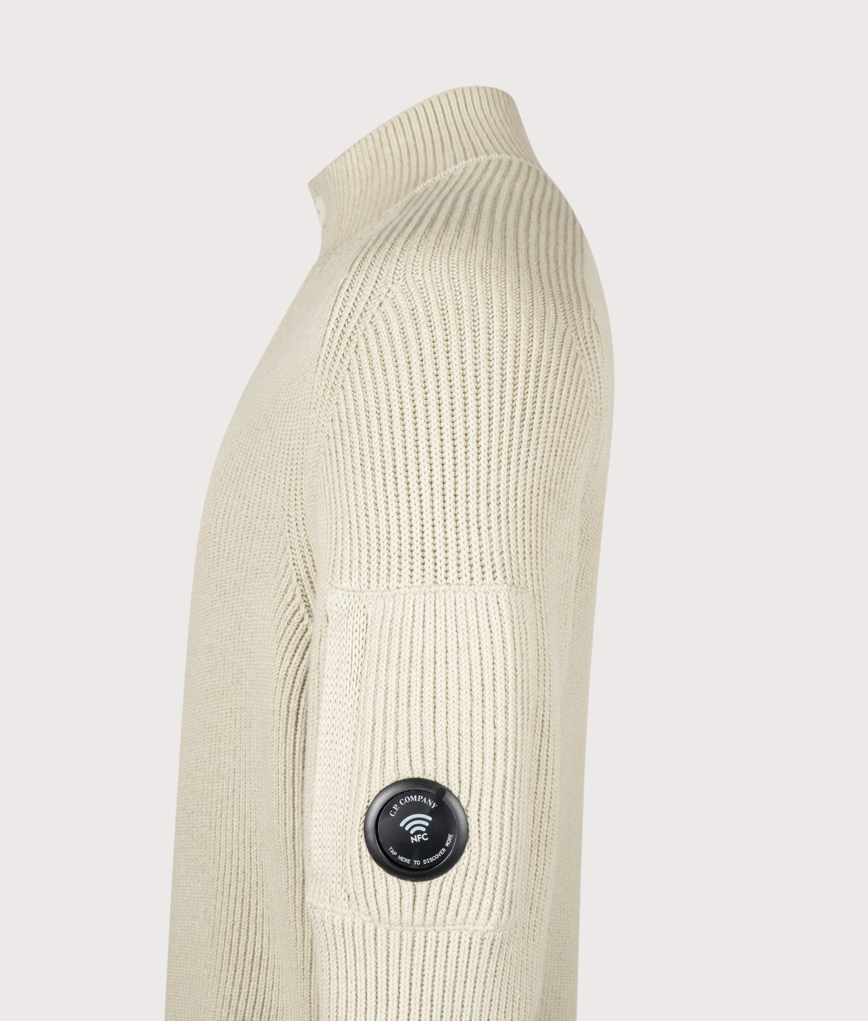 C.P. Company Full Rib Cotton Half Button Lens Jumper in Silver Birch at EQVVS Menswear. NFC Detail shot.